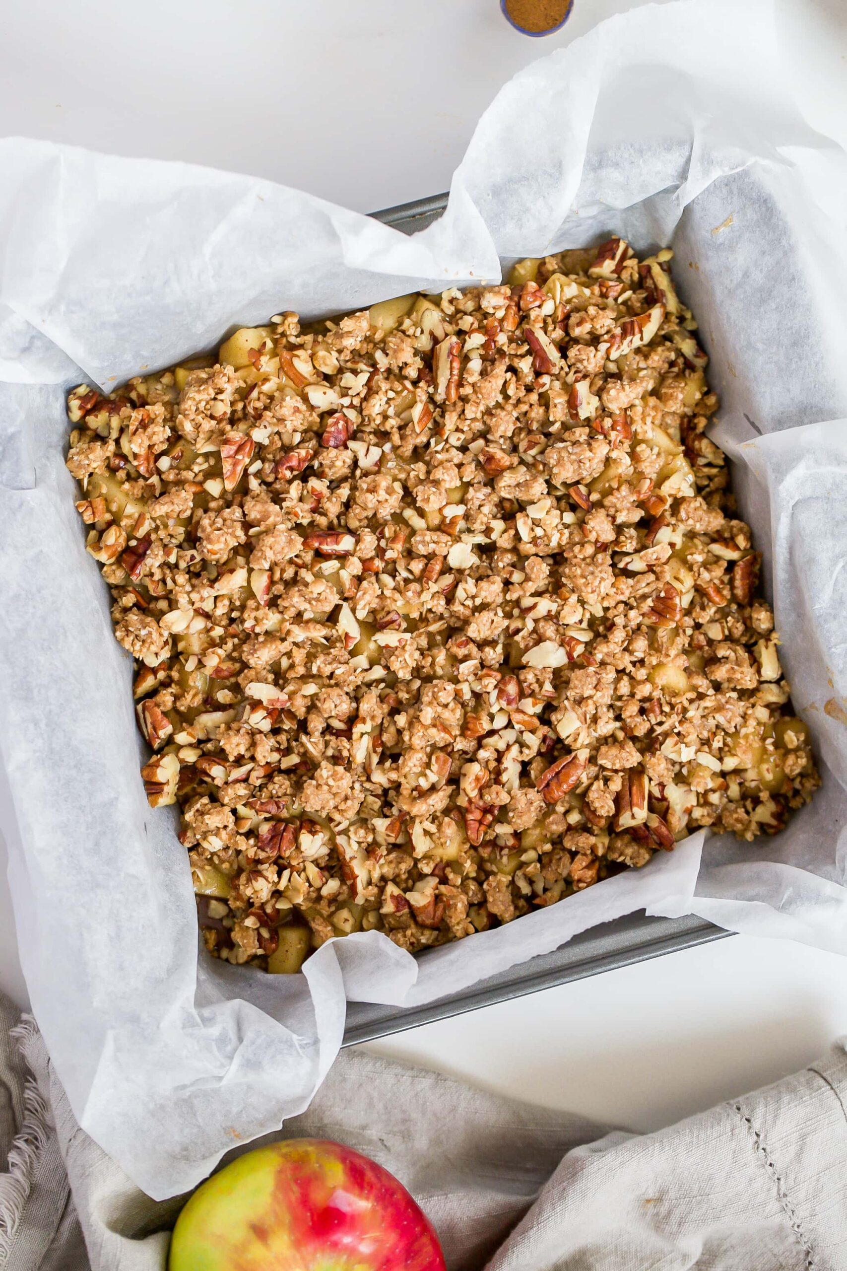 apple crumble in pan with topping