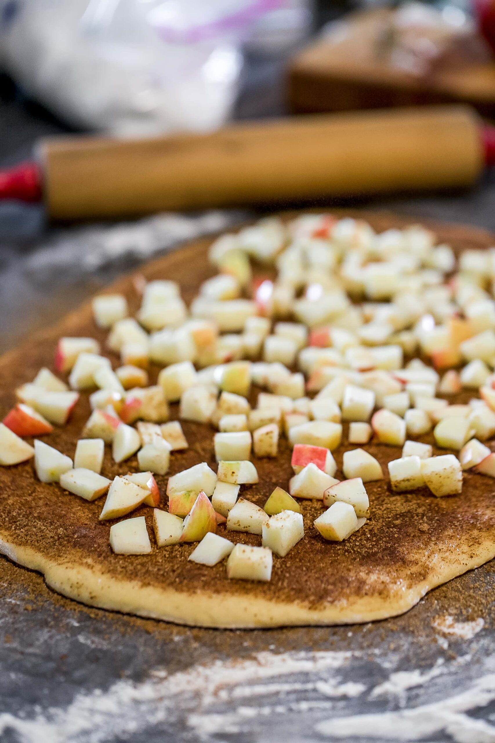 chopped apples on cinnamon rolls