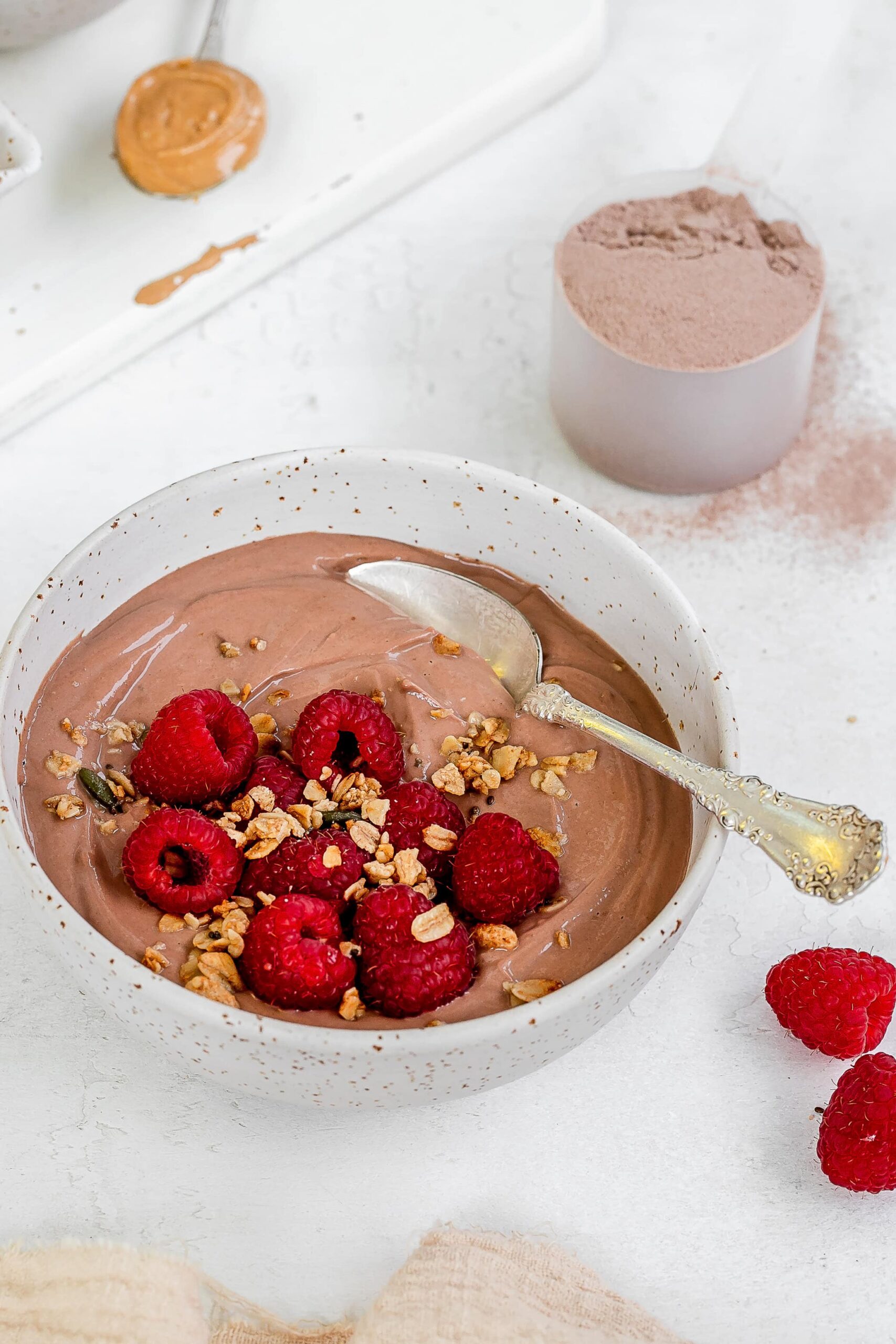 greek yogurt with protein powder in a bowl with berries.