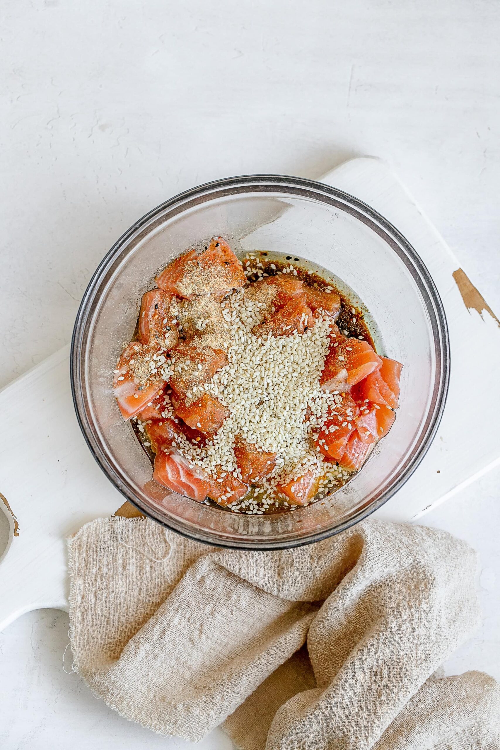 cubed salmon in bowl with seasoning.