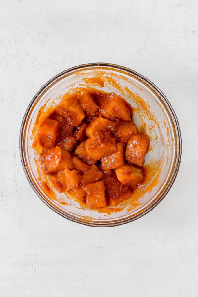 salmon tossed in sauce in large bowl.