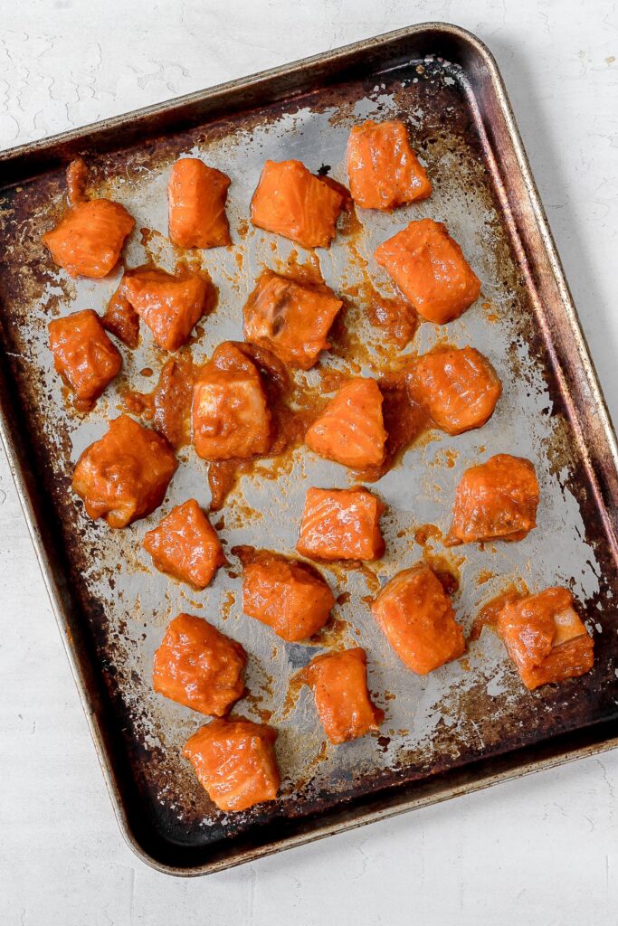 salmon cubes on baking sheet before broiling.