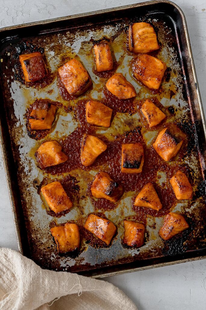 salmon cubes on baking tray after broiling.