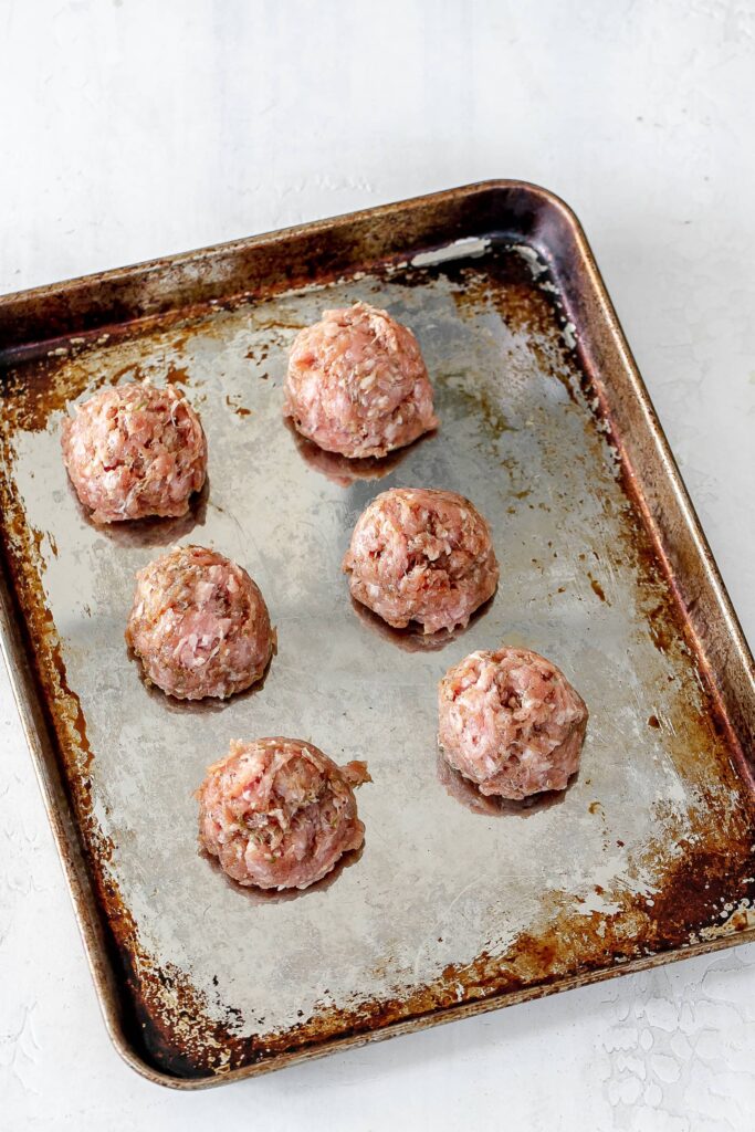 pork meatballs on baking sheet.