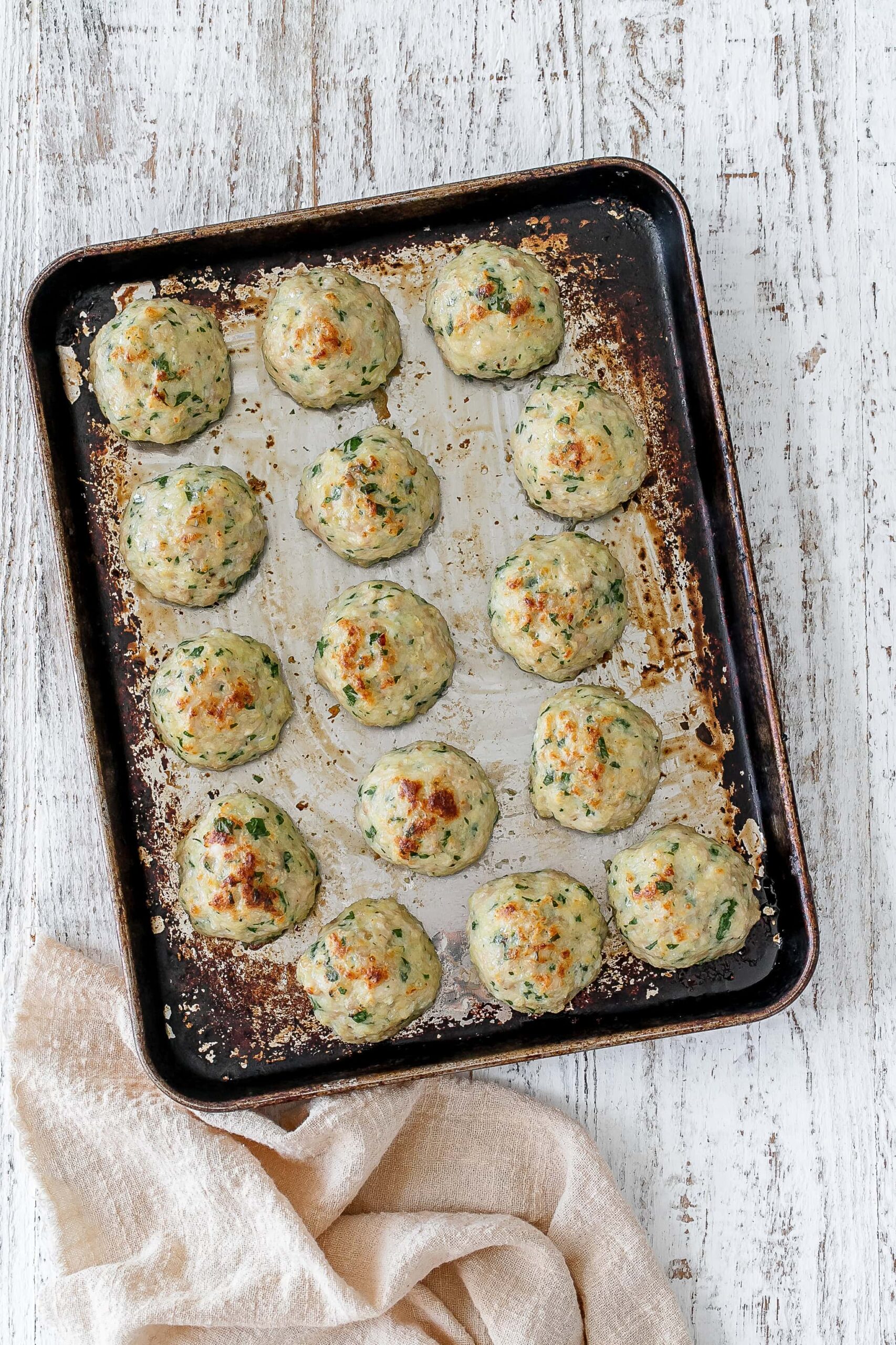 chicken meatballs on a baking sheet.