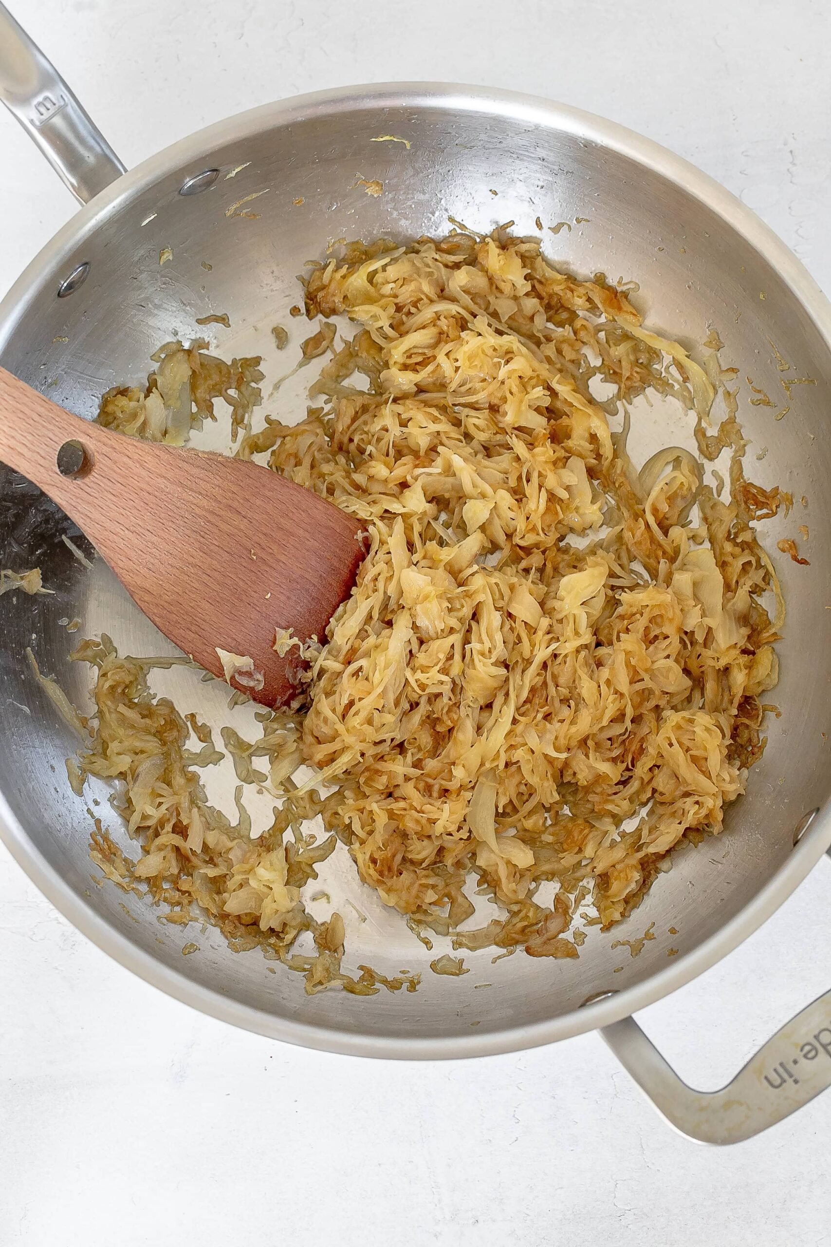 cabbage and onions in skillet cooking.