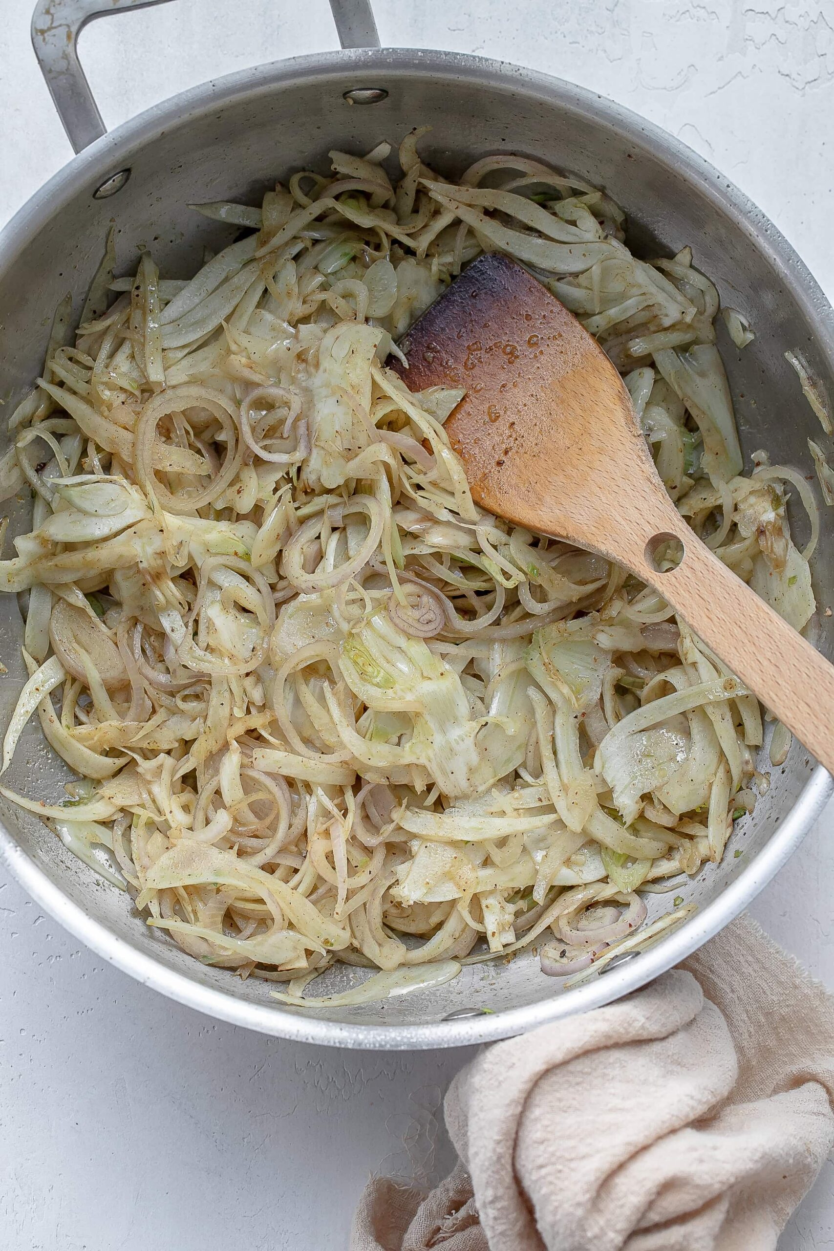 fennel and shallot in skillet cooking.