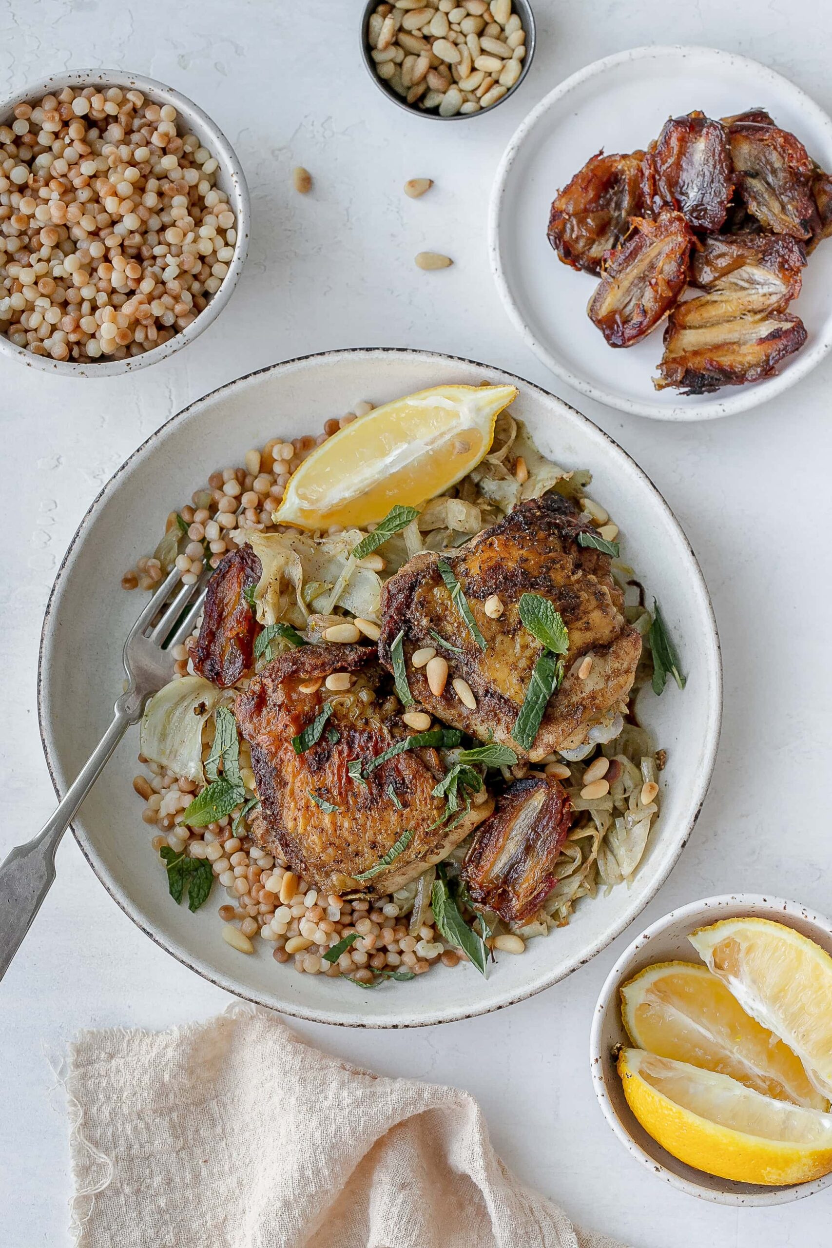 chicken thighs with fennel on a plate with couscous. 