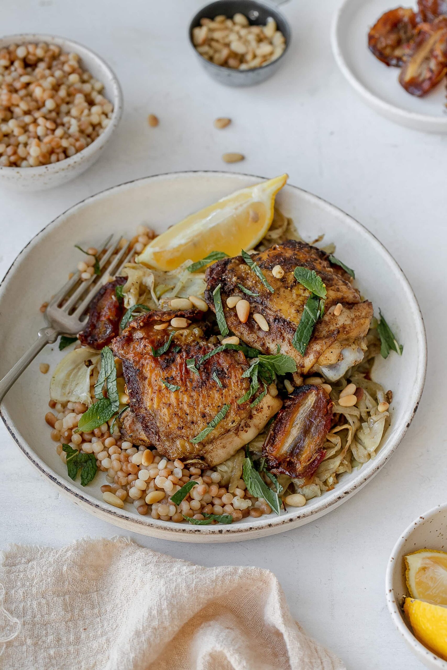 chicken thighs with fennel on a plate with couscous. 