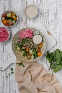 ground lamb bowl with tahini sauce on the side.