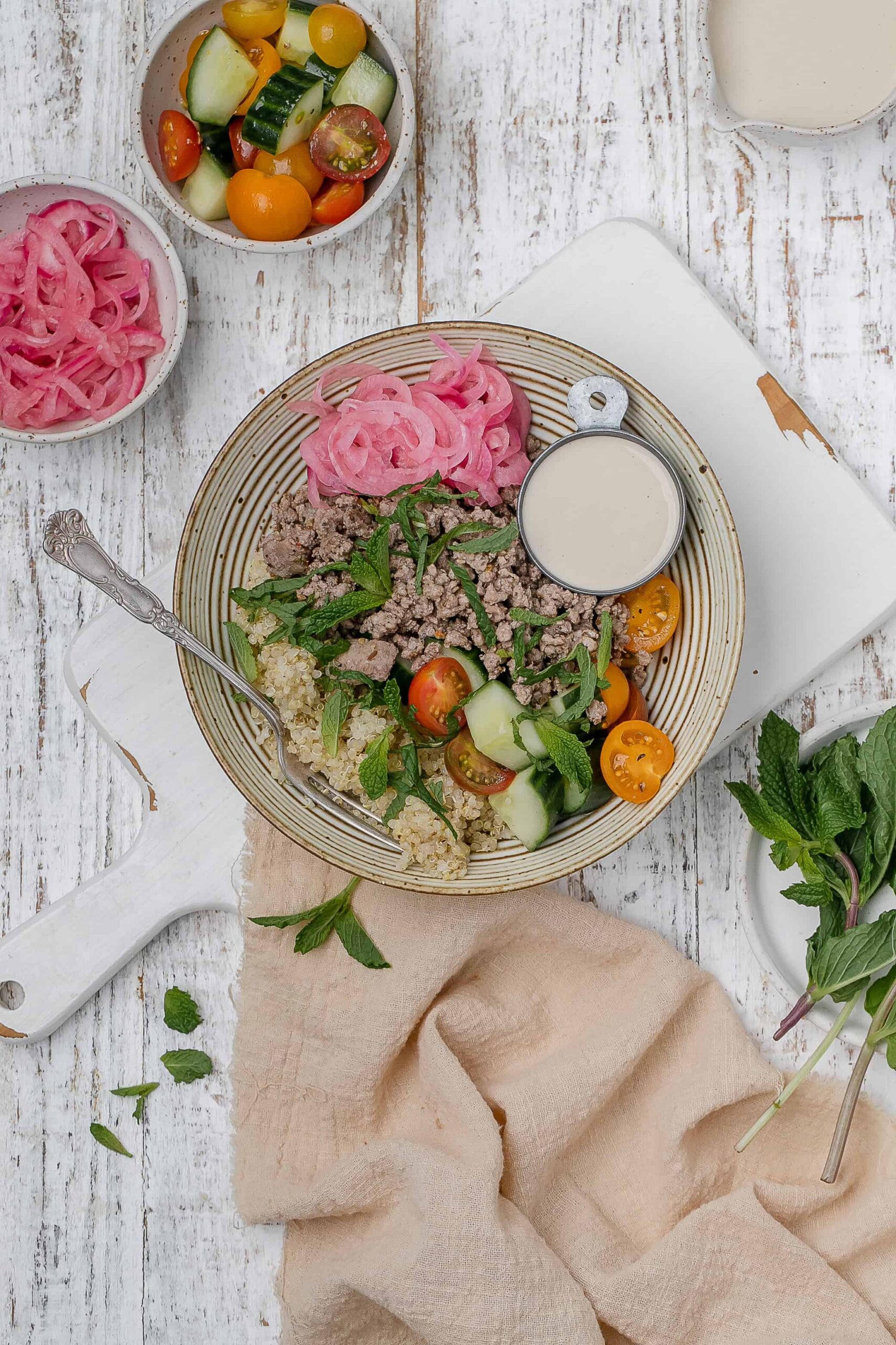 ground lamb bowl with tahini sauce on the side. 