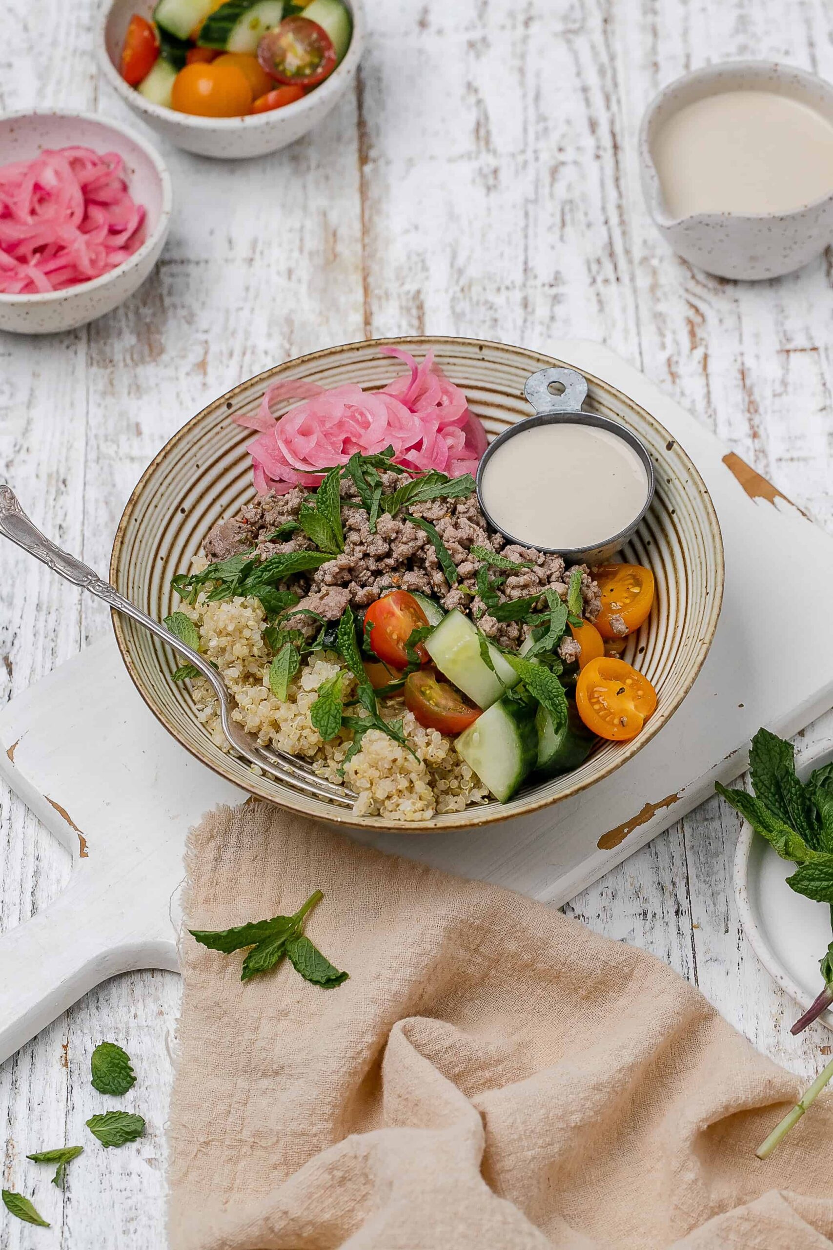 ground lamb bowl with tahini sauce on the side. 