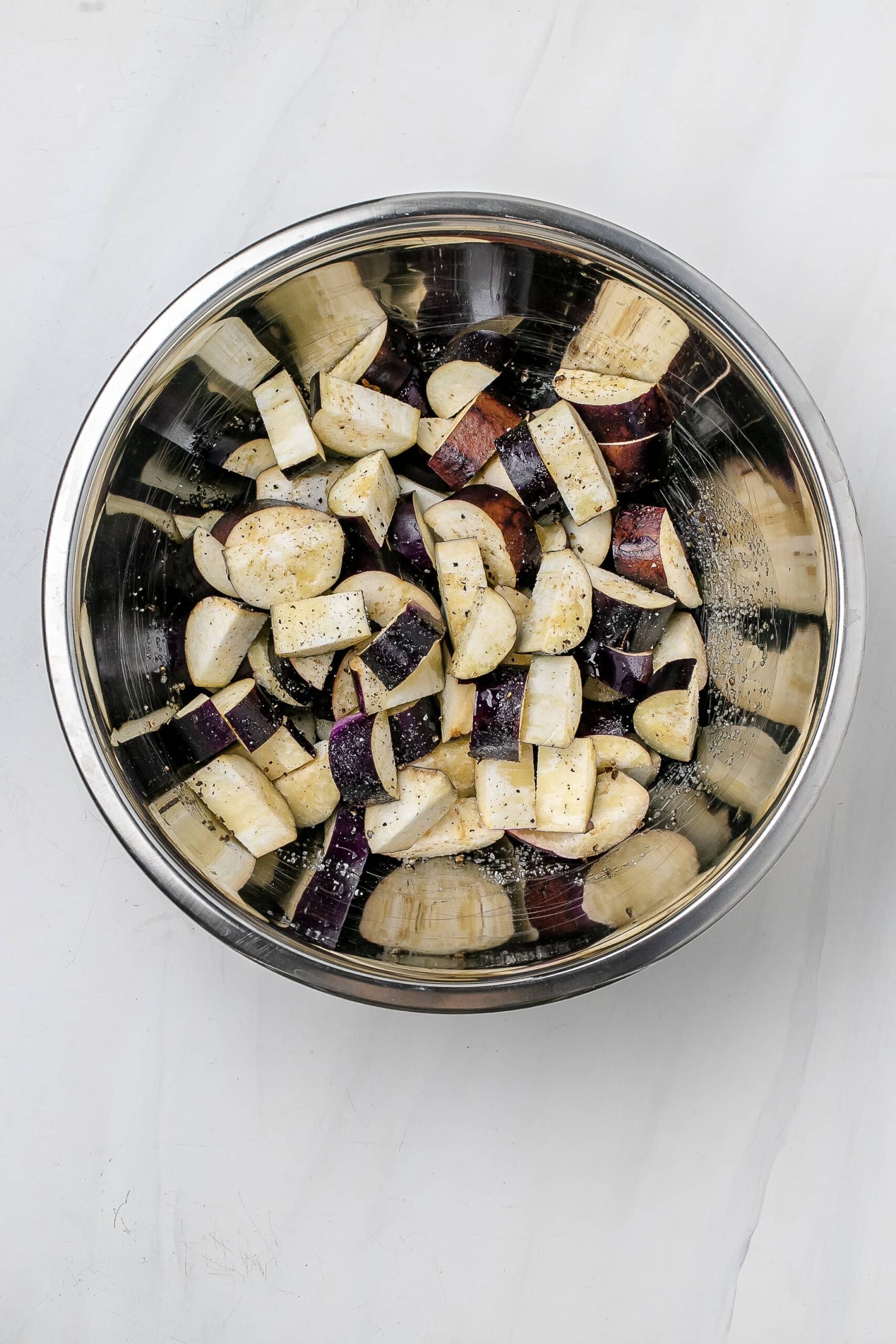 eggplant in half moons in mixing bowl.