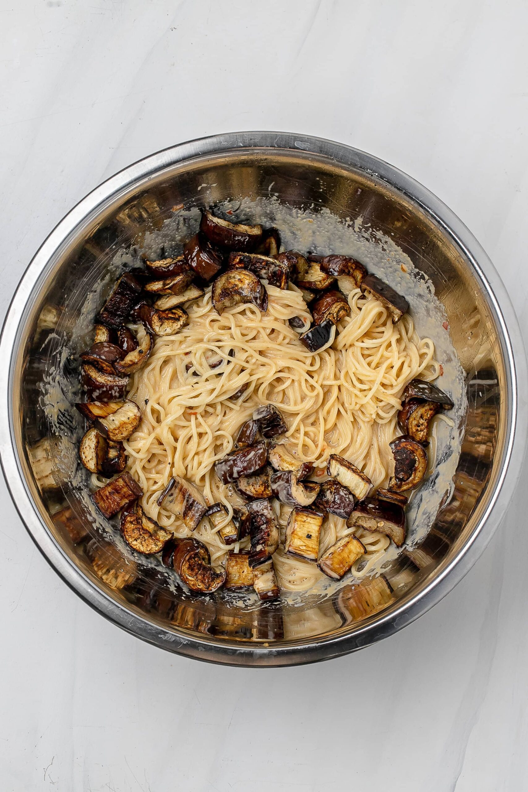eggplant added to noodles and sauce. 