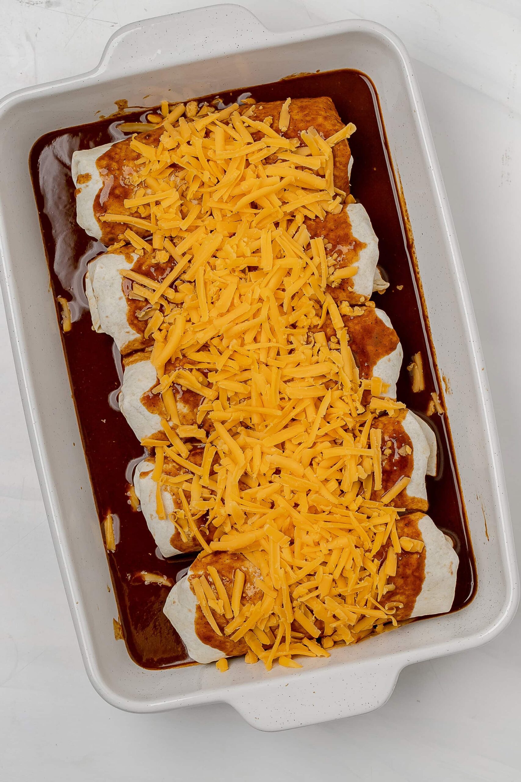 enchiladas in baking dish before baking. 