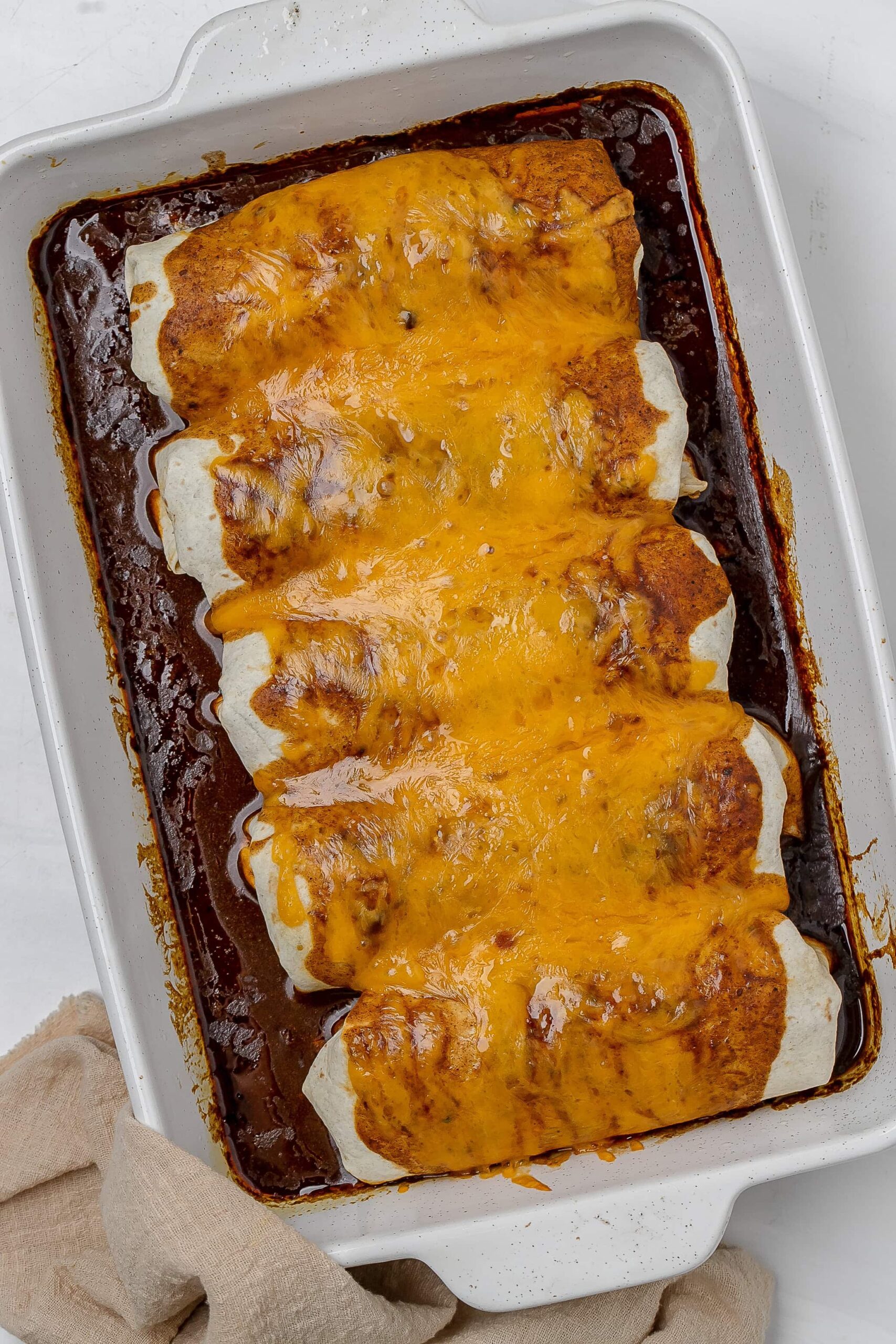 cooked enchiladas in baking dish.