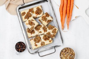 carrot cake cookie bars with cheesecake swirl on a baking sheet.