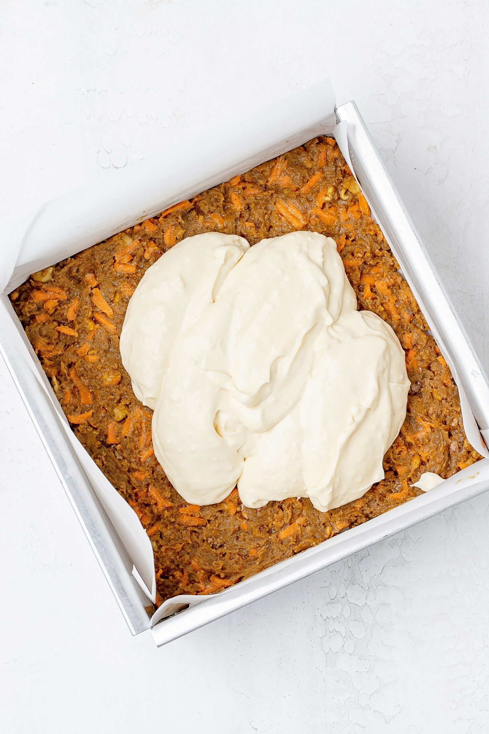 cream cheese layer added on top of cookie bars. 