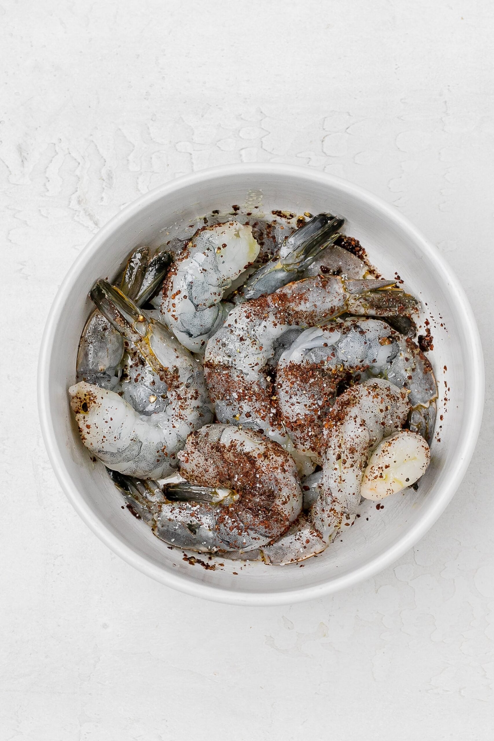 shrimp in bowl with seasoning. 