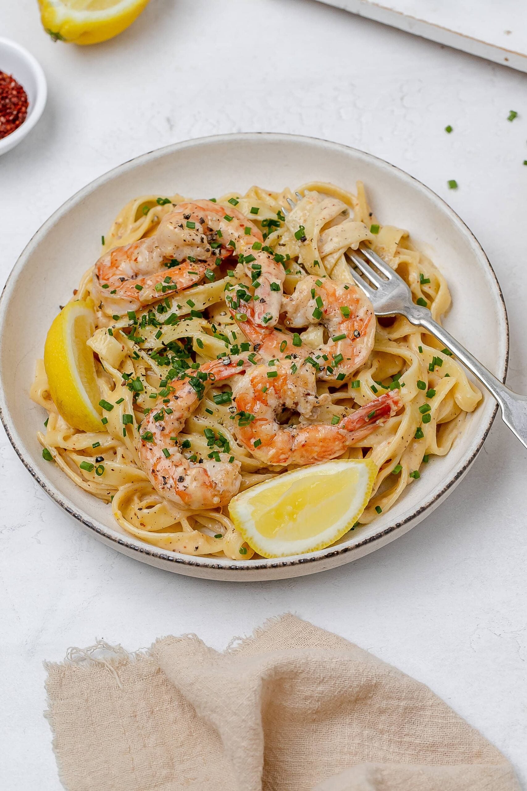 creamy lemon pasta with shrimp on a plate. 