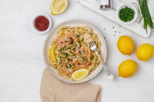 creamy lemon pasta with shrimp on a plate.