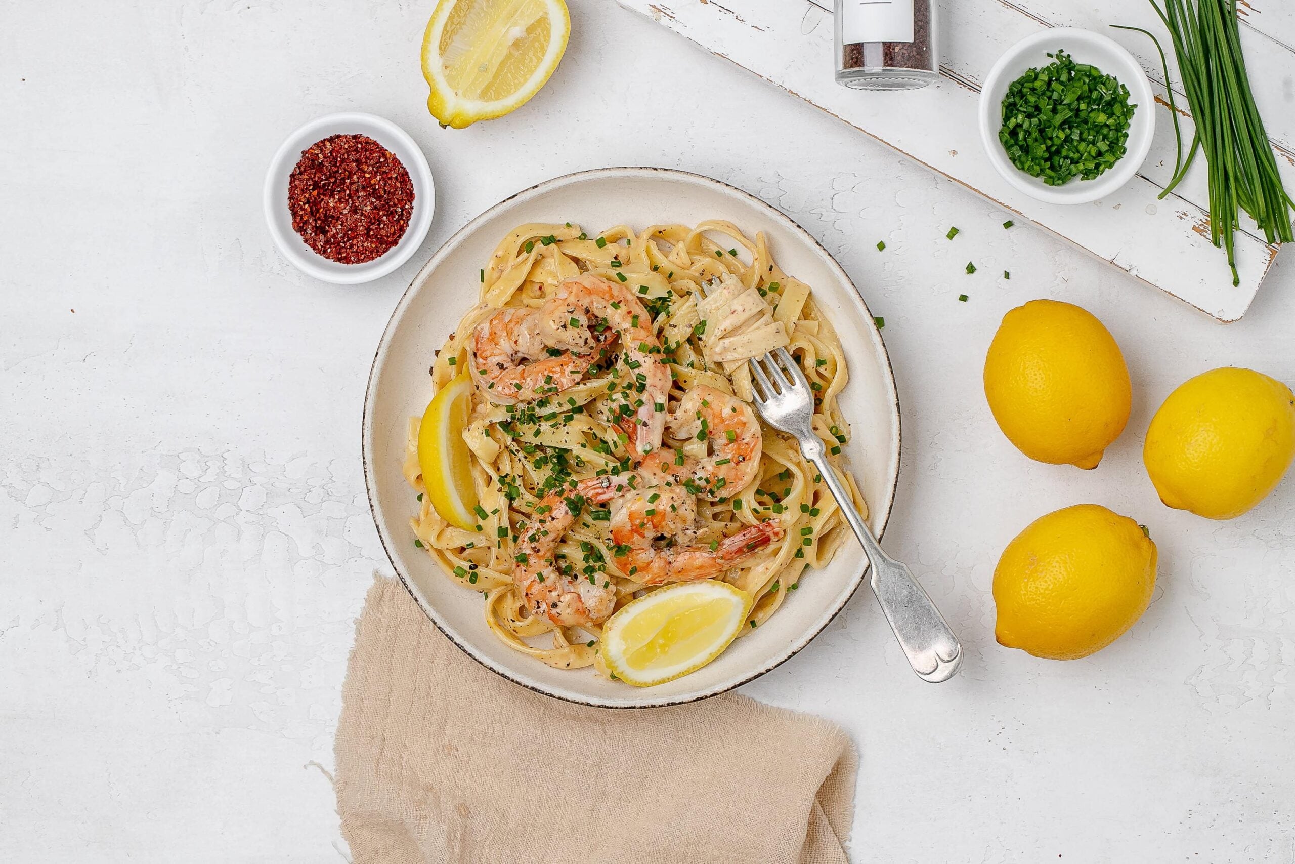creamy lemon pasta with shrimp on a plate.