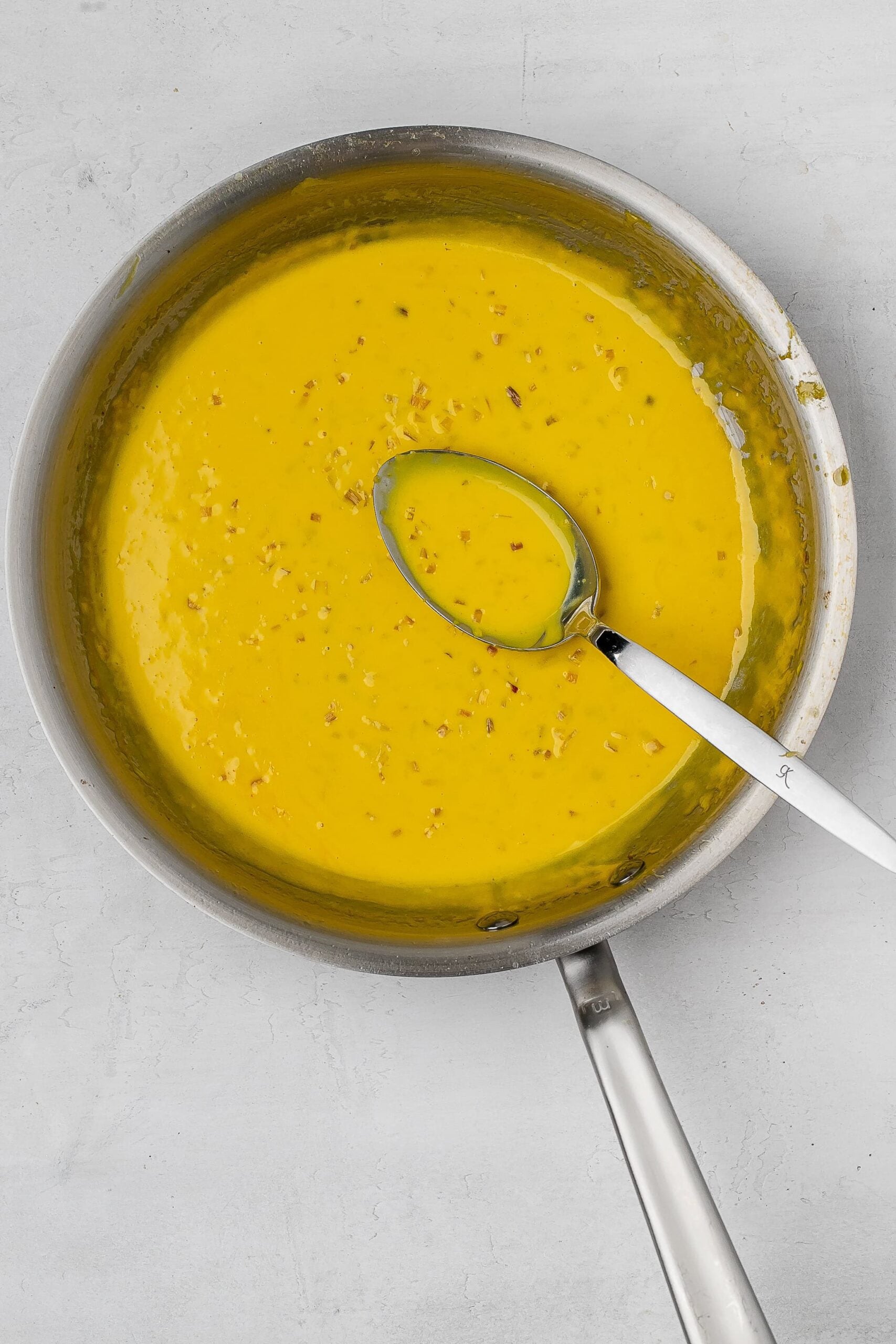 saffron cream sauce in saucier.