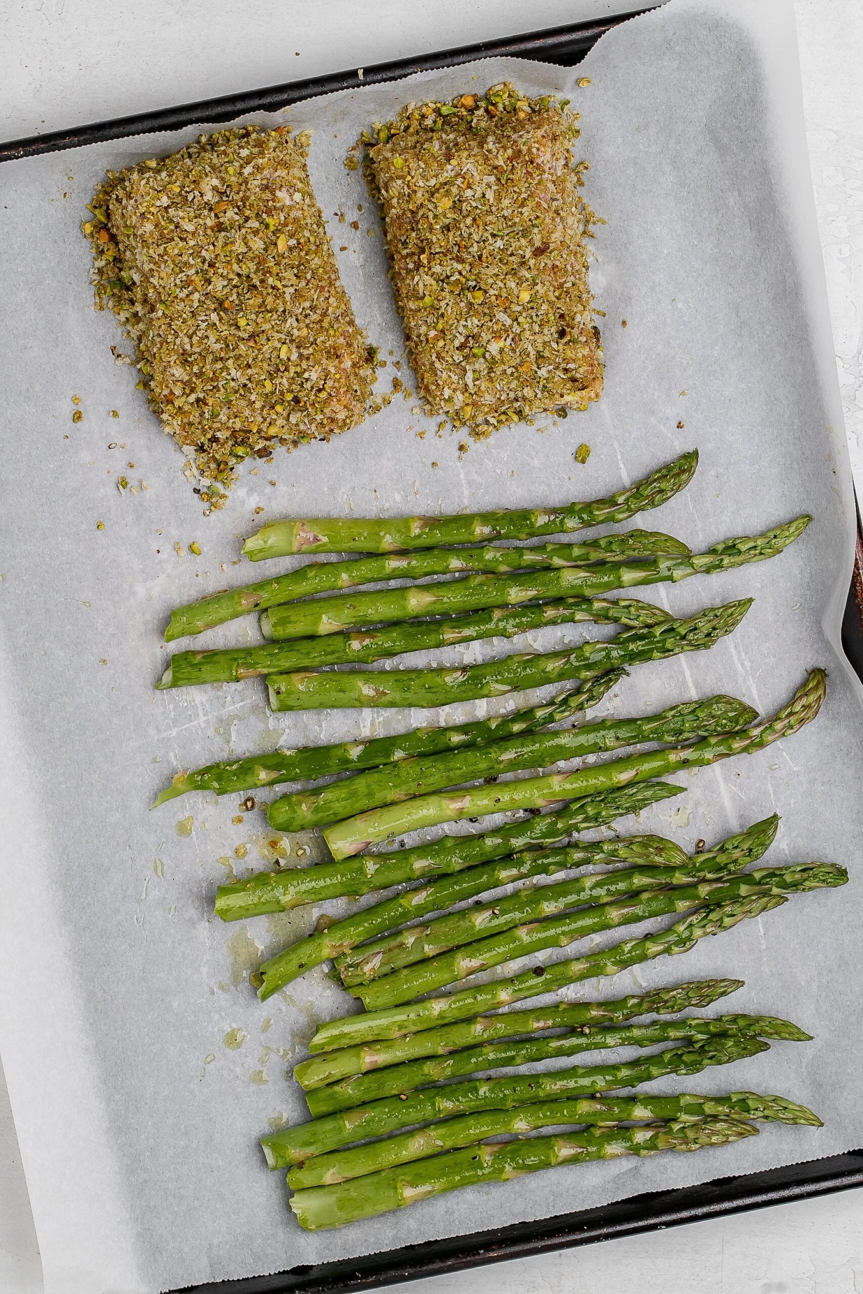 salmon and asparagus on baking sheet.