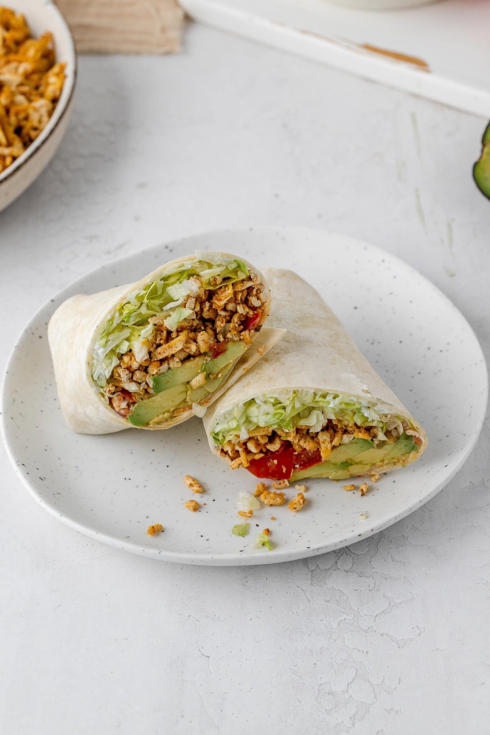 shredded taco spiced tofu wrap on a plate.