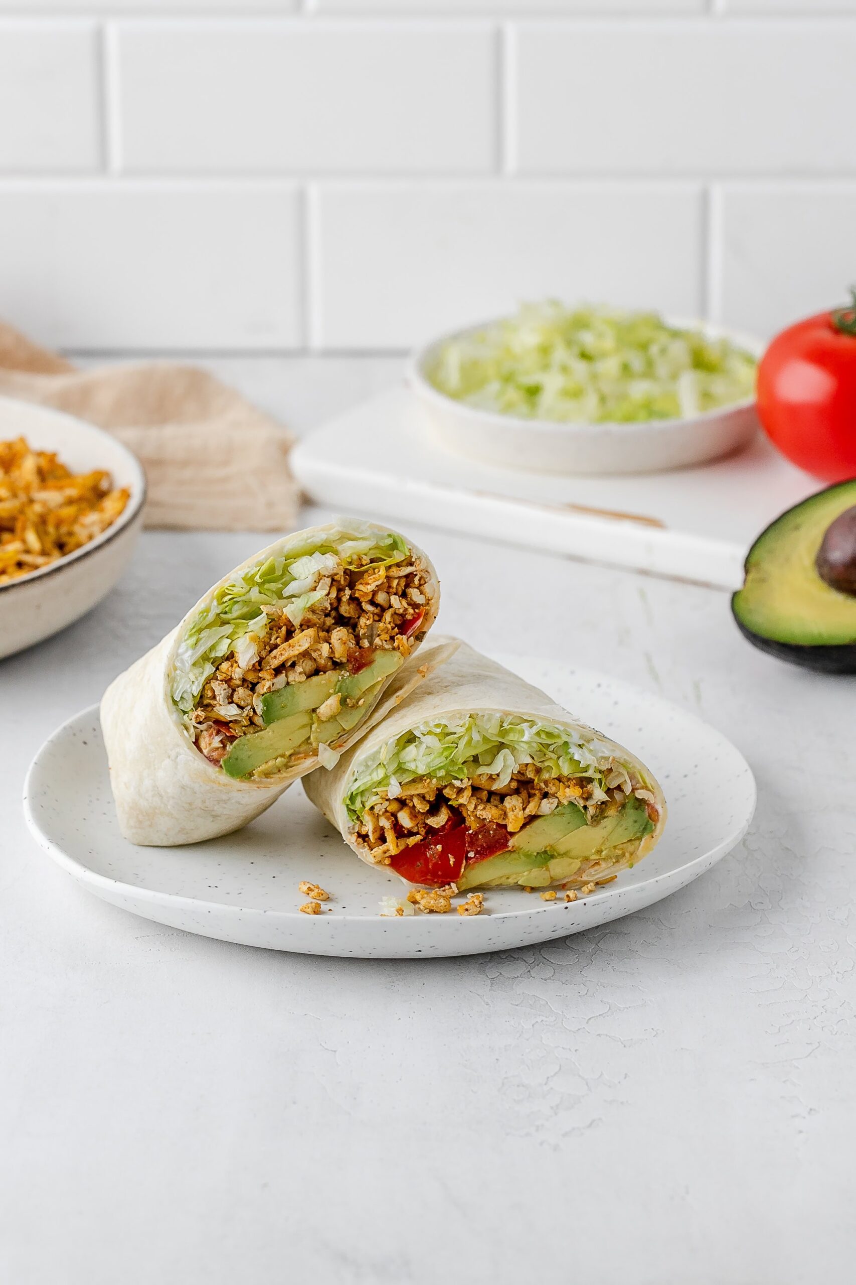 shredded taco spiced tofu wrap on a plate.