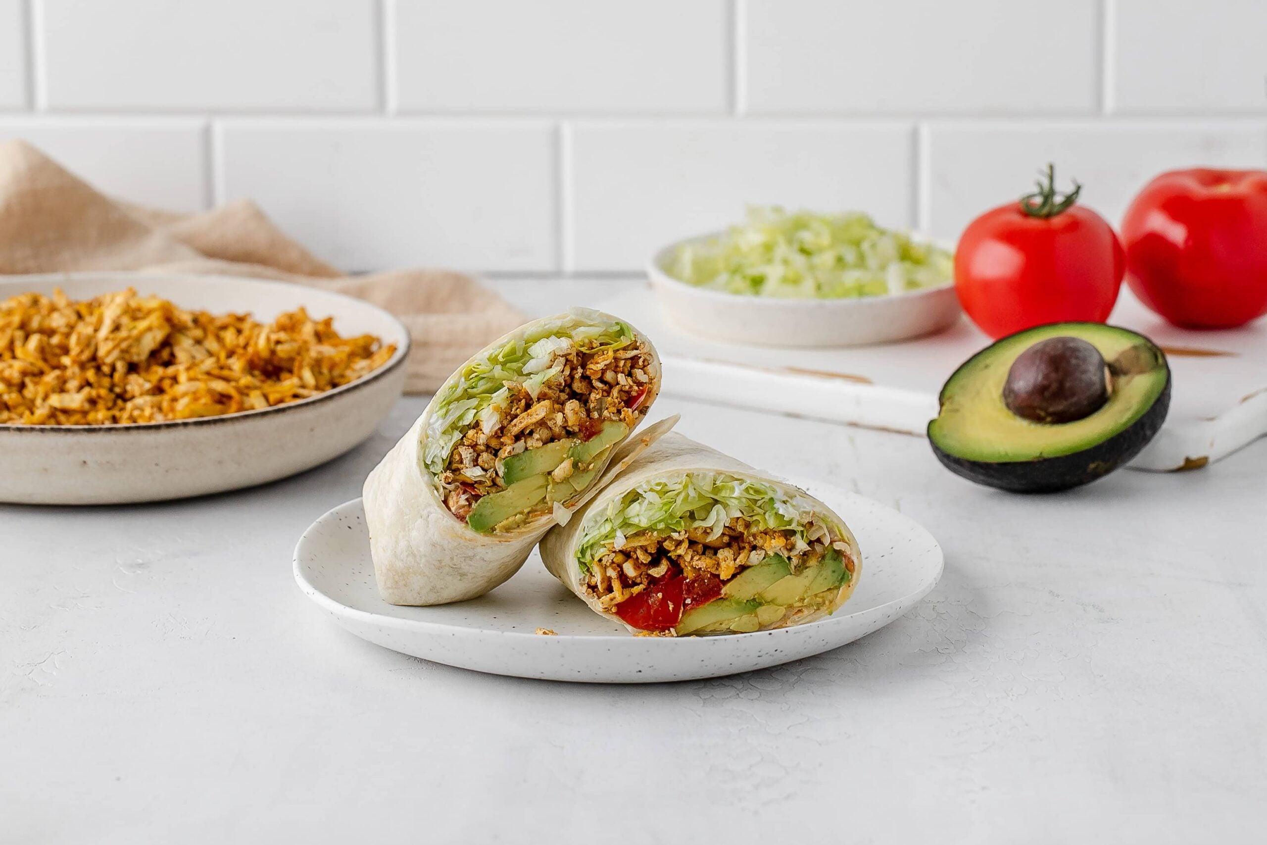 shredded taco spiced tofu wrap on a plate.