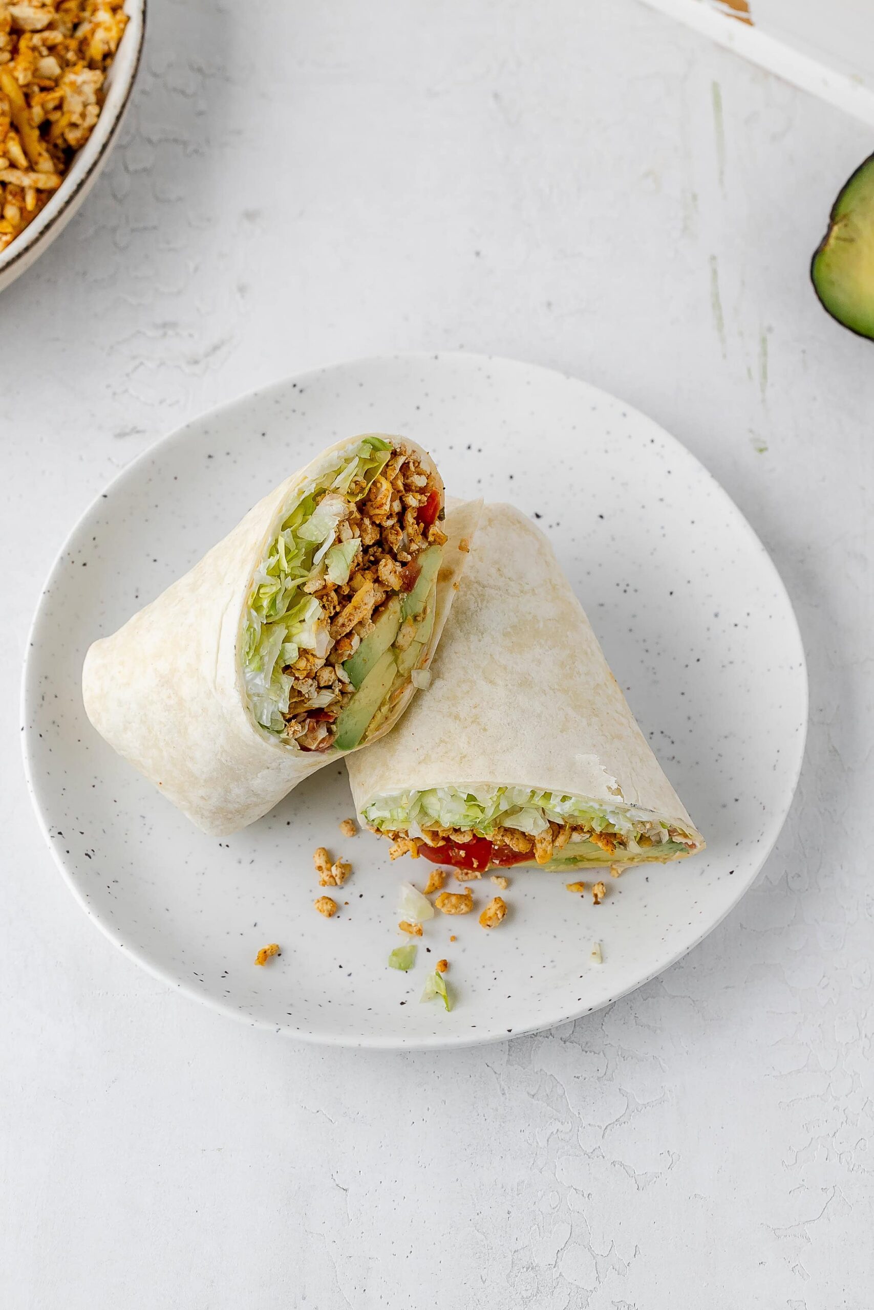 shredded taco spiced tofu wrap on a plate.