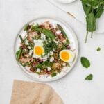 asparagus farro salad on a plate with a jammy egg.