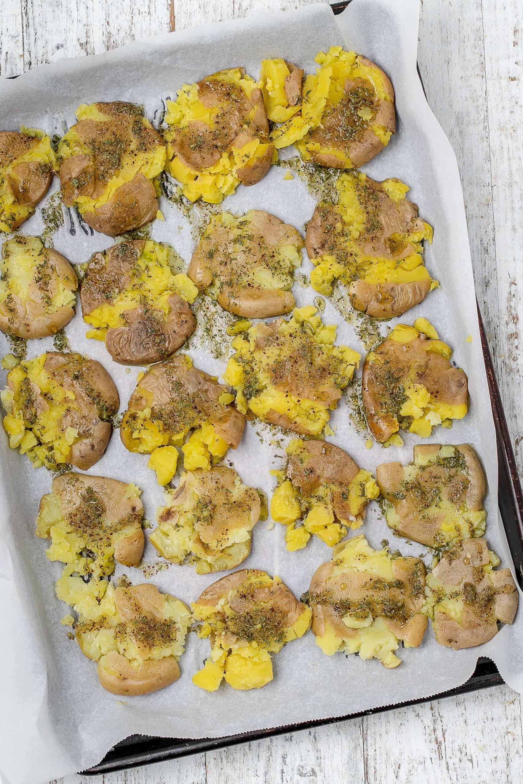 smashed potatoes with herb oil drizzled on top.