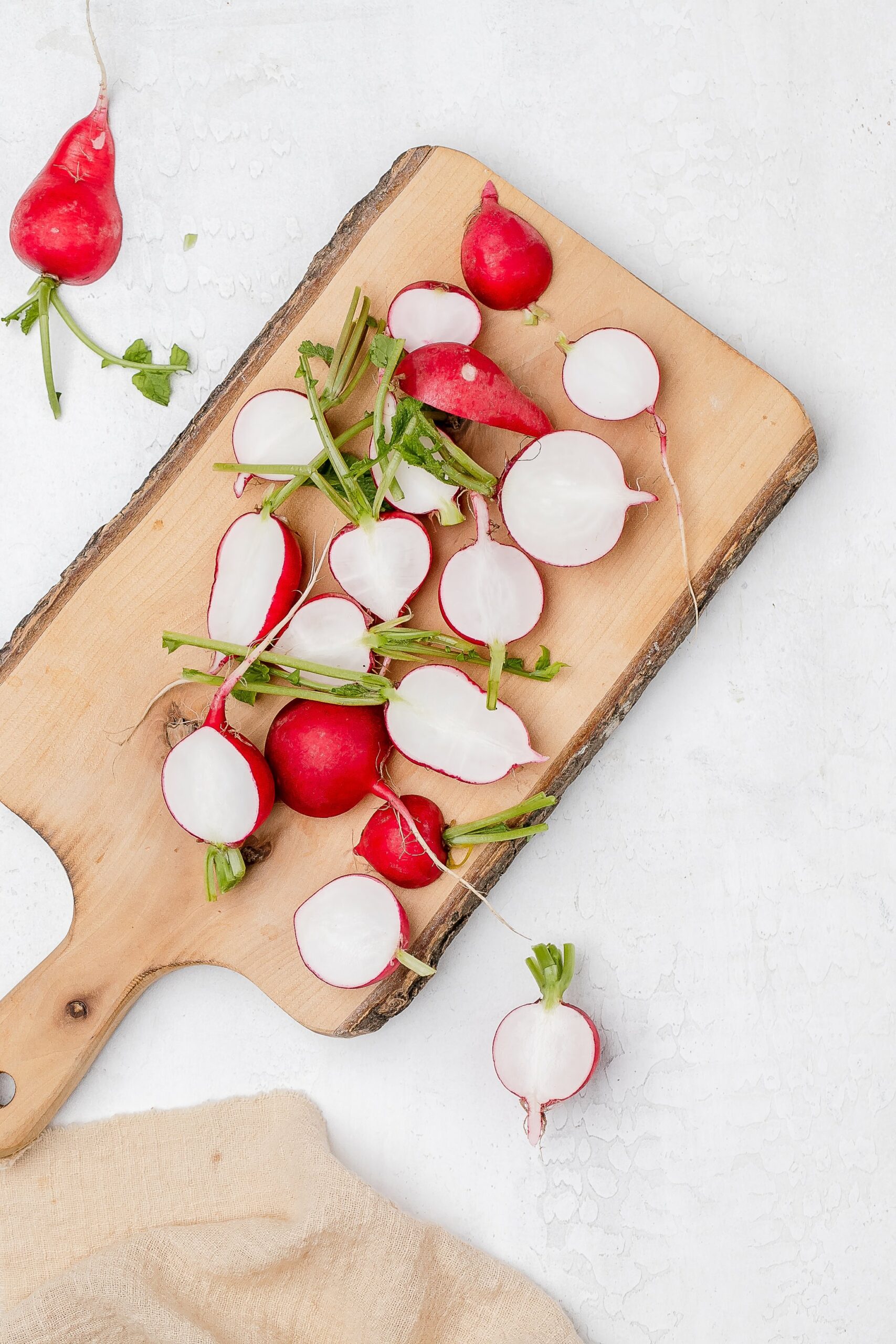 radishes halved on a cutting board.