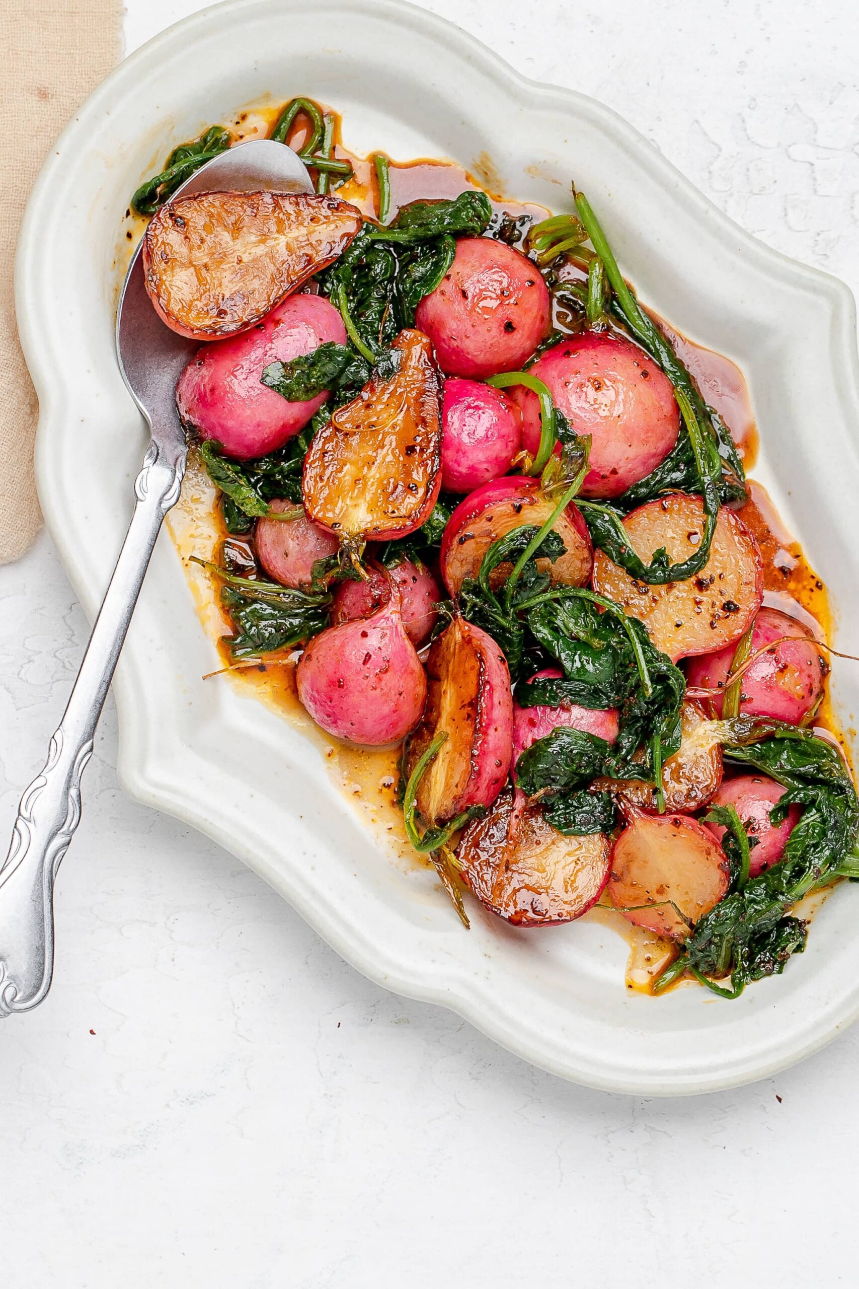 sautéed radishes on a platter with butter sauce.