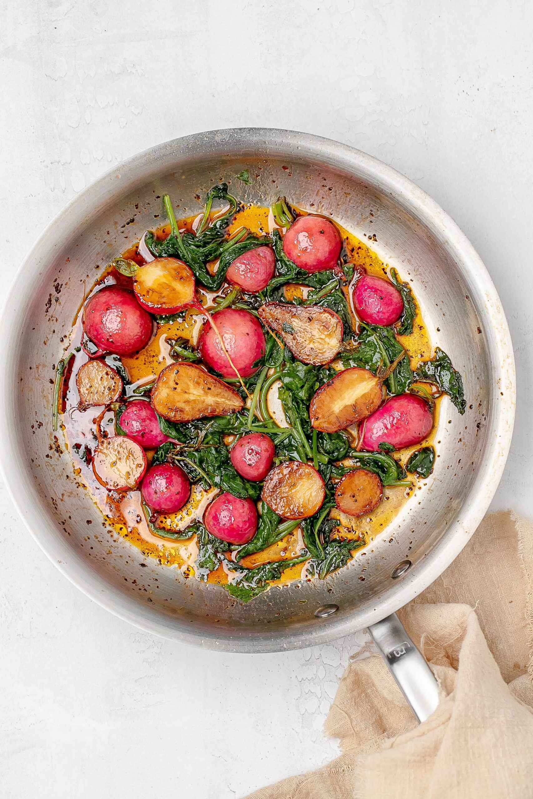 radishes and greens in a skillet.