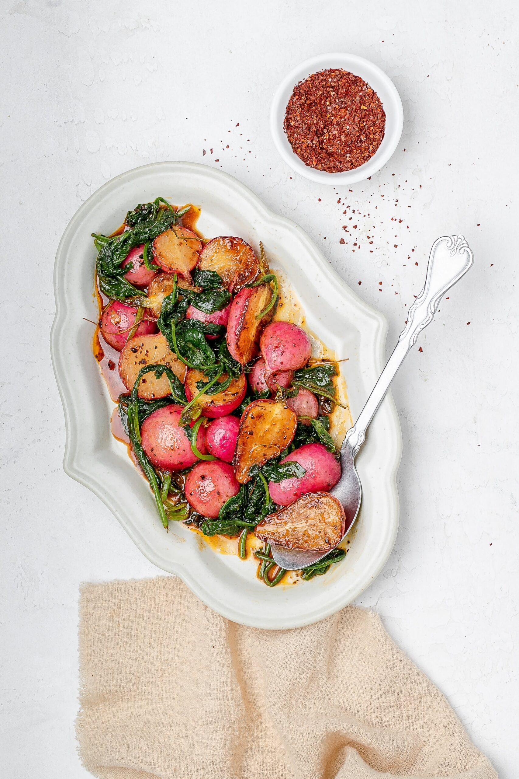 sautéed radishes on a platter with butter sauce.