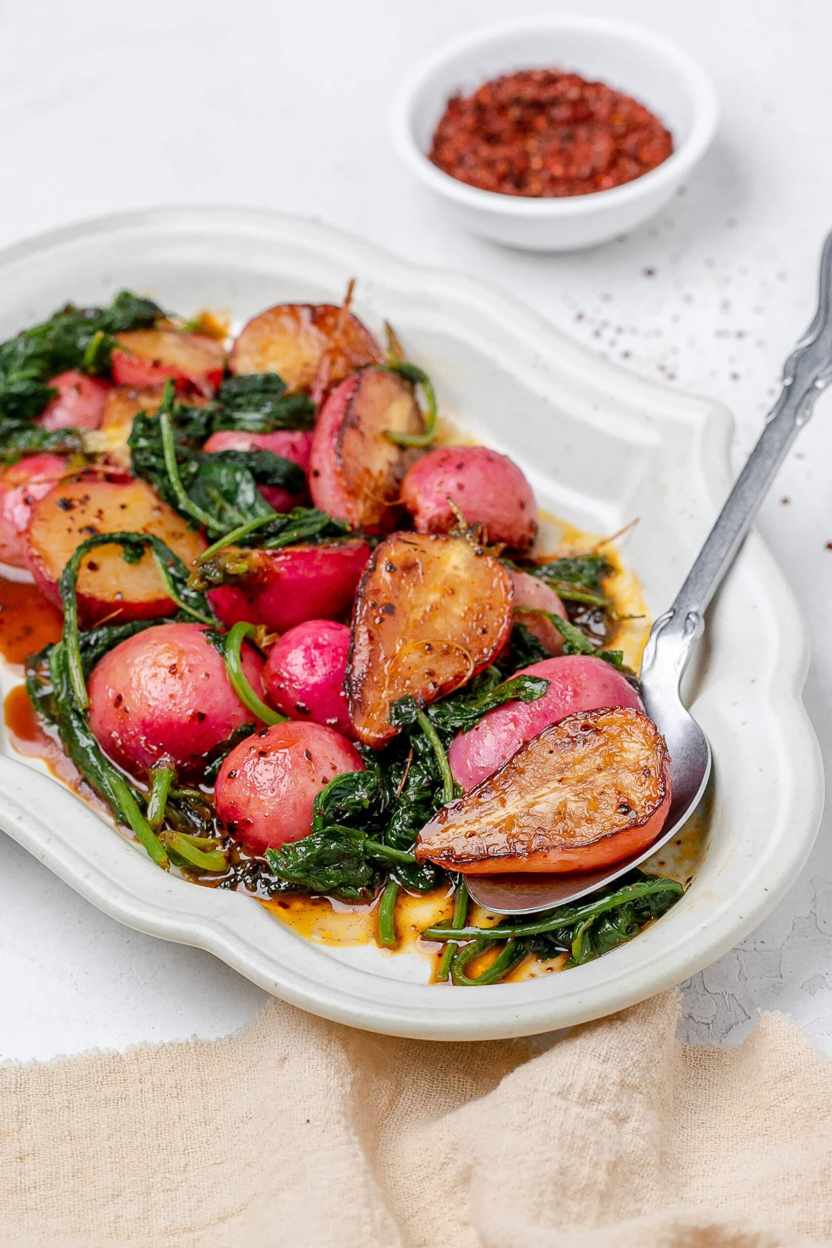 sautéed radishes on a platter with butter sauce.