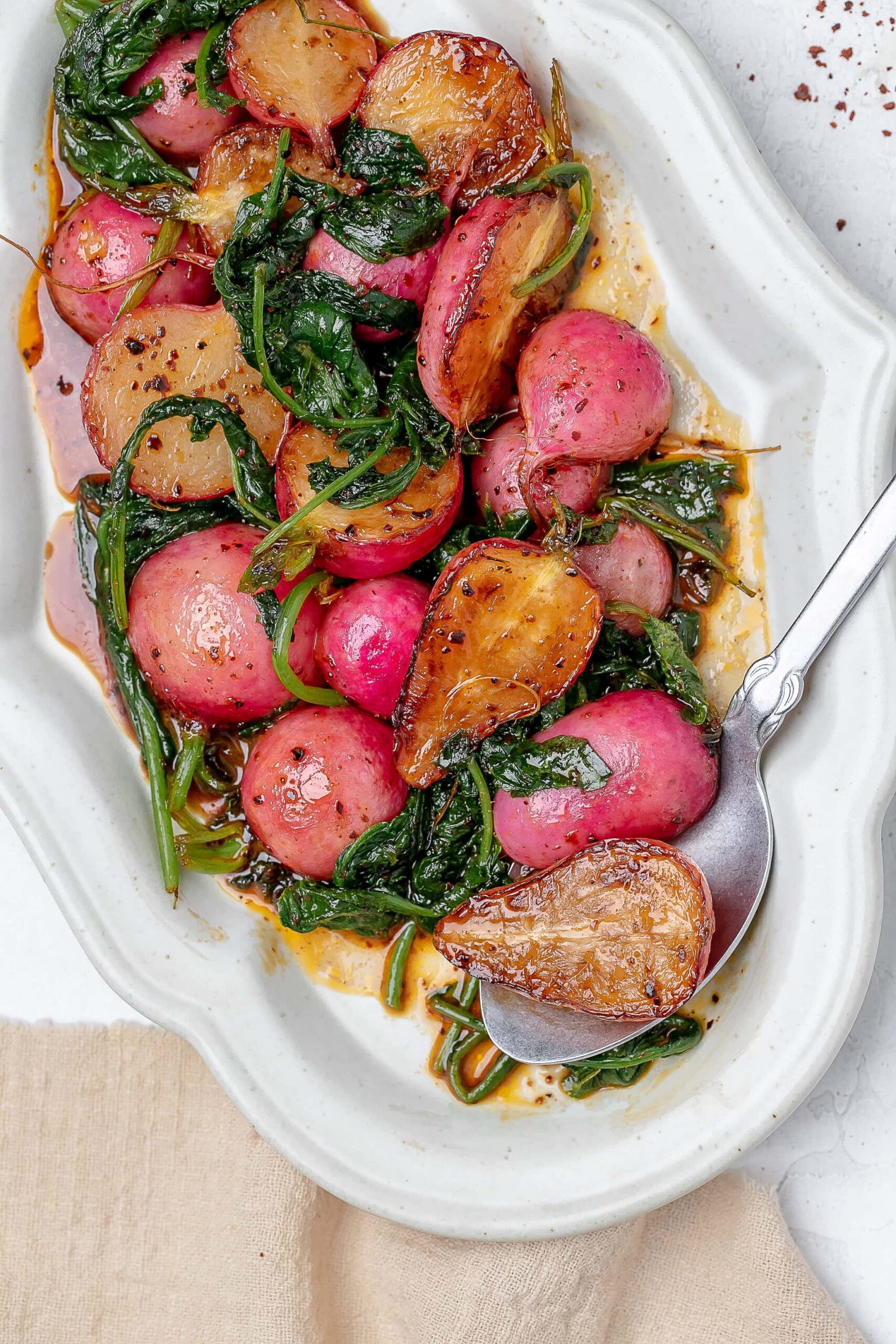 sautéed radishes on a platter with butter sauce.