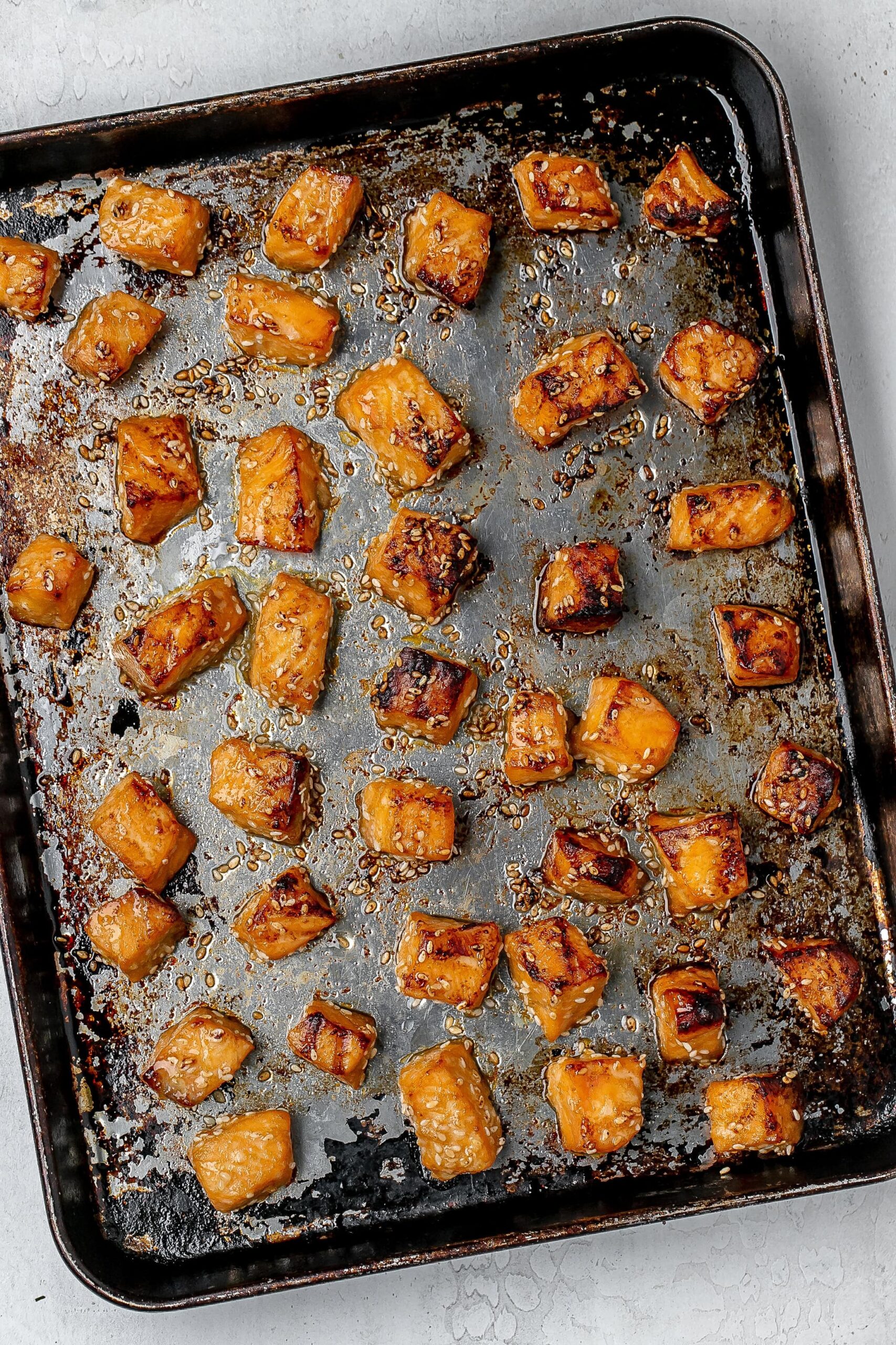 broiled salmon on a baking sheet.