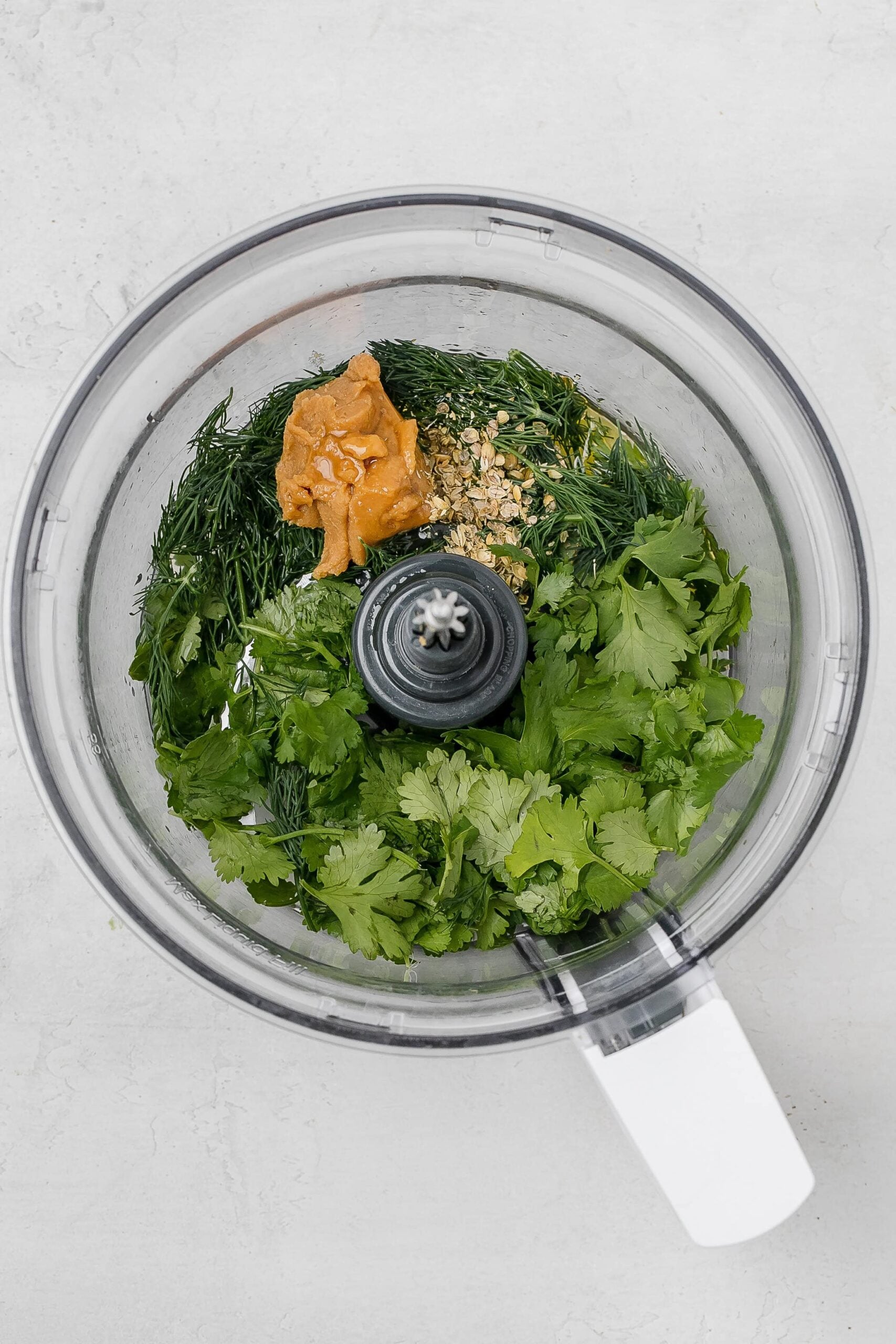ingredients for green sauce in food processor.