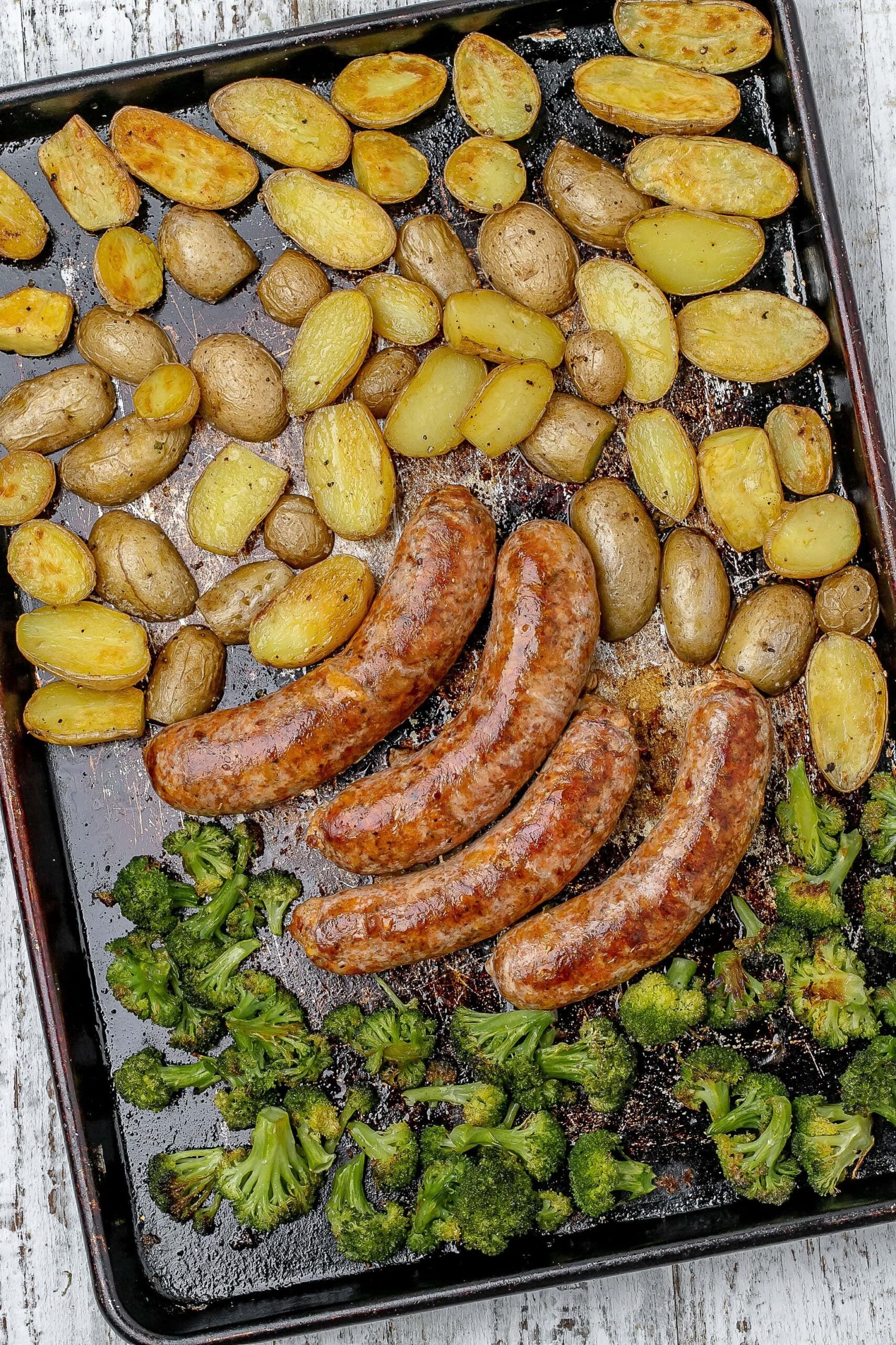 sausage, potato and broccoli on a sheet pan.