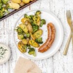 sausage, potato and broccoli on a plate.