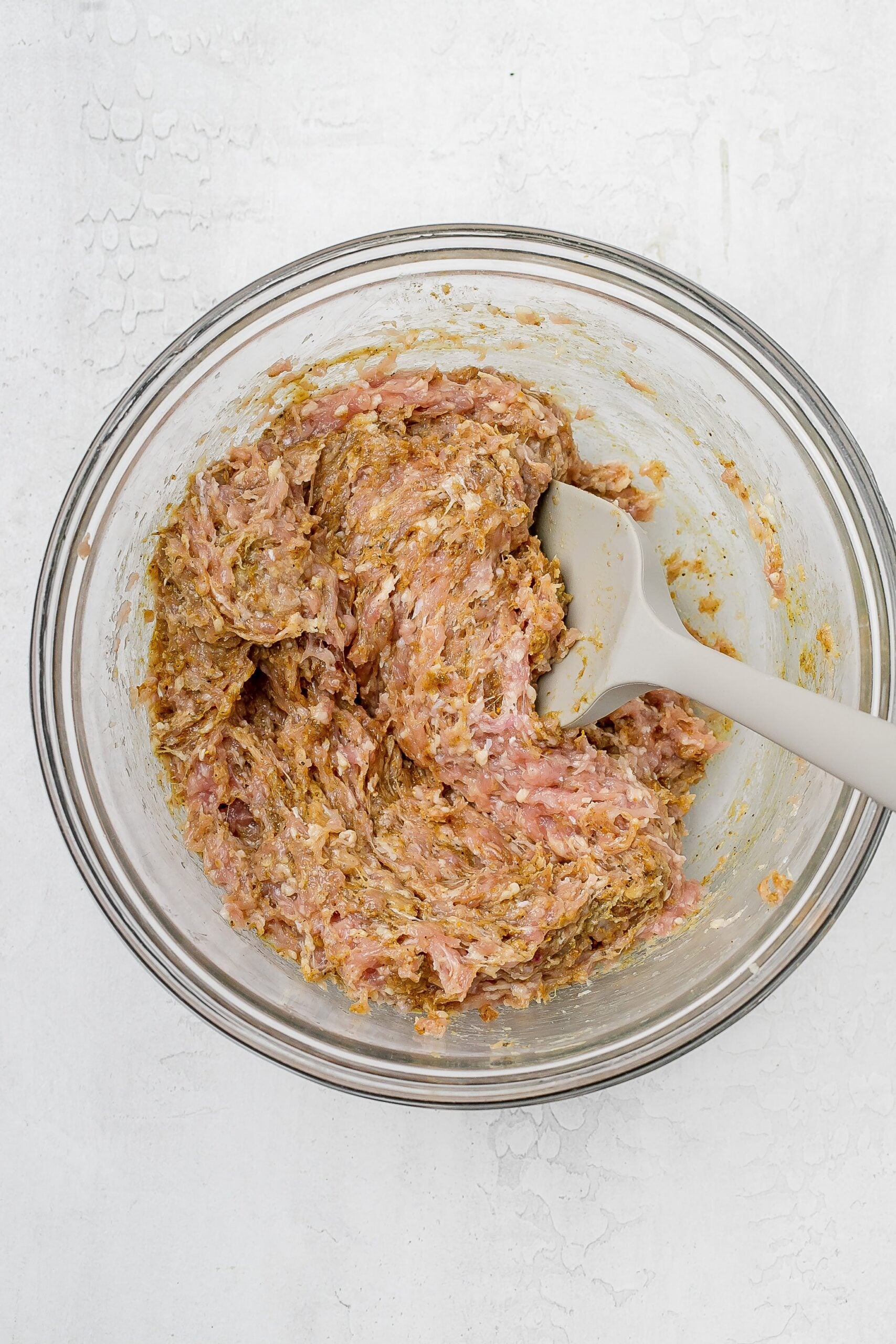 ground chicken mixture with spices 
in a bowl.