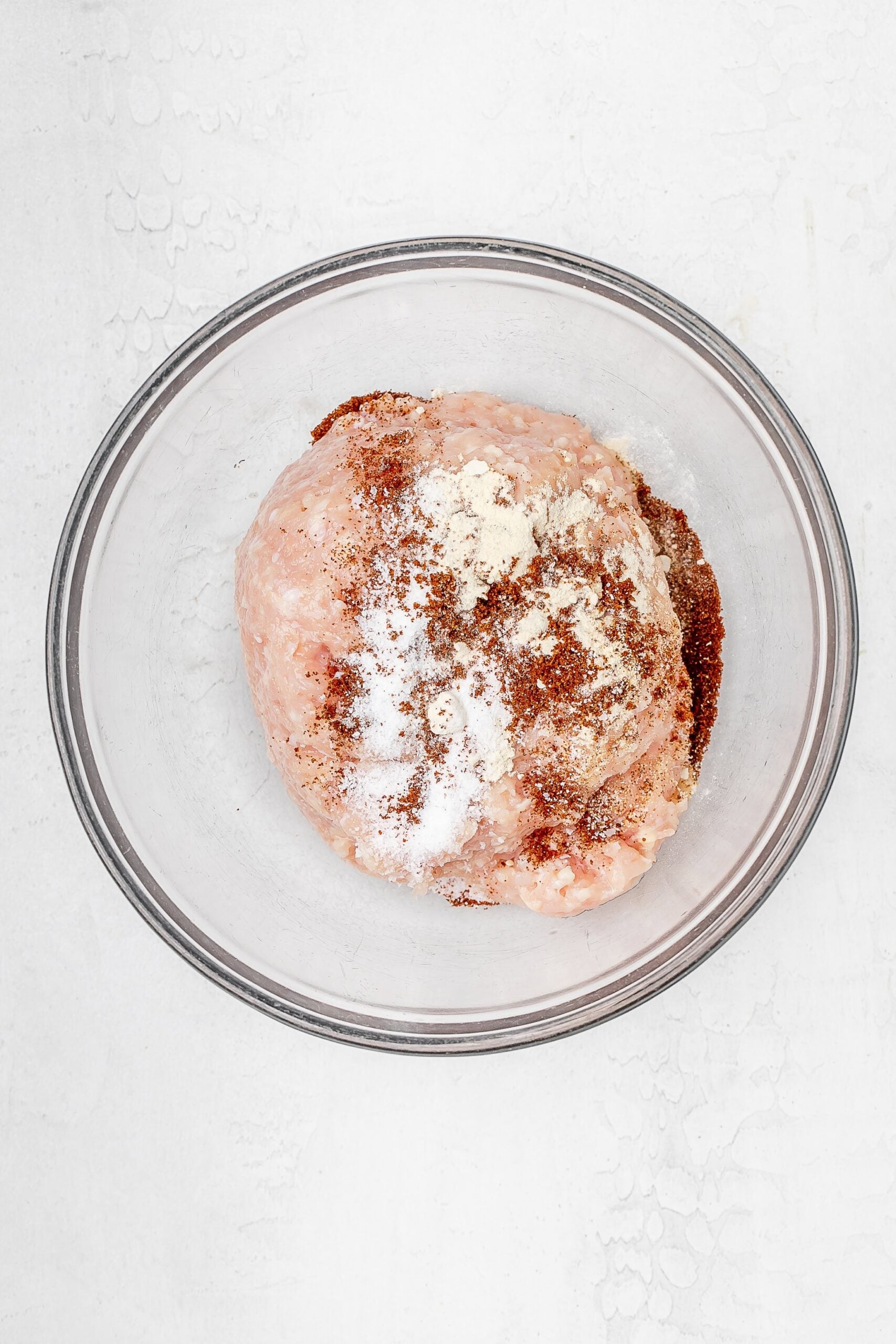 ground chicken in a bowl with spices. 