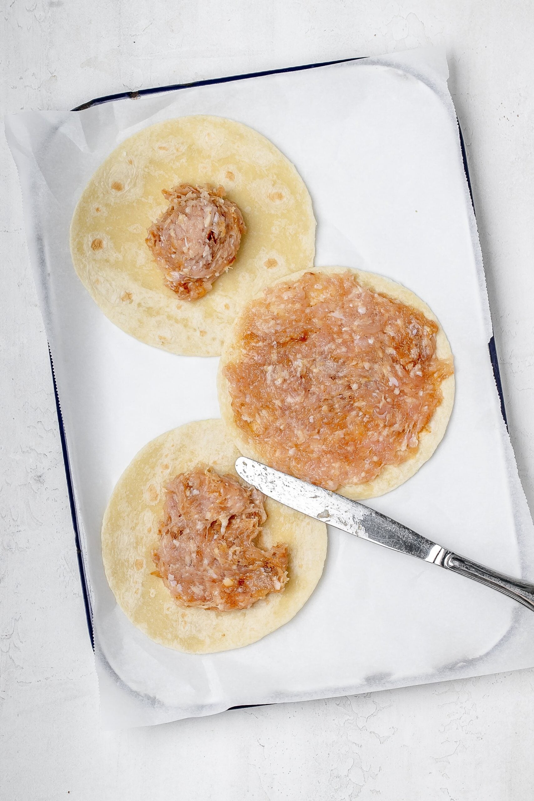 ground chicken spread onto tortillas. 