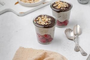 blended chia pudding in jars with chocolate ganache topping.