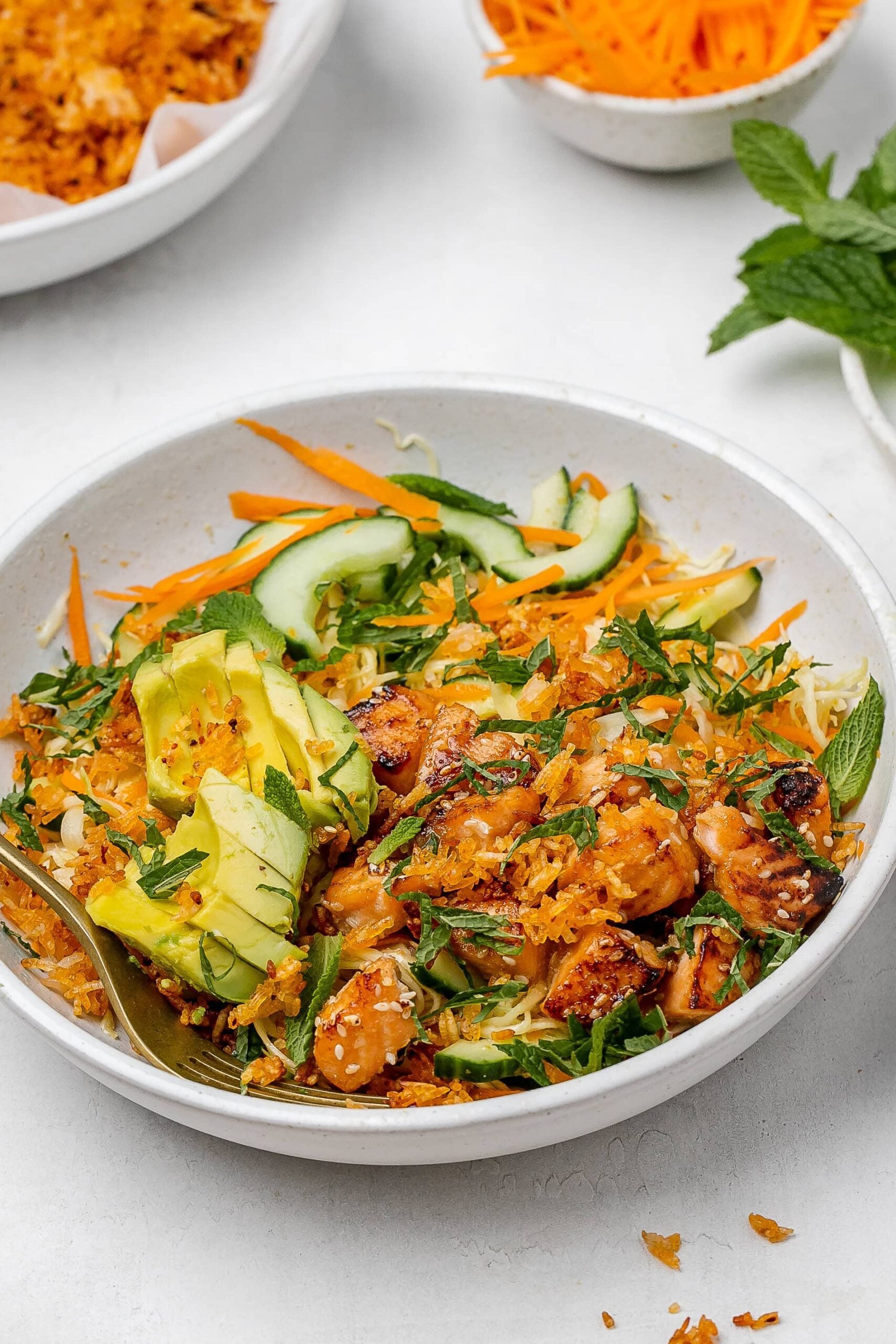 crispy rice salad with salmon in a salad bowl.
