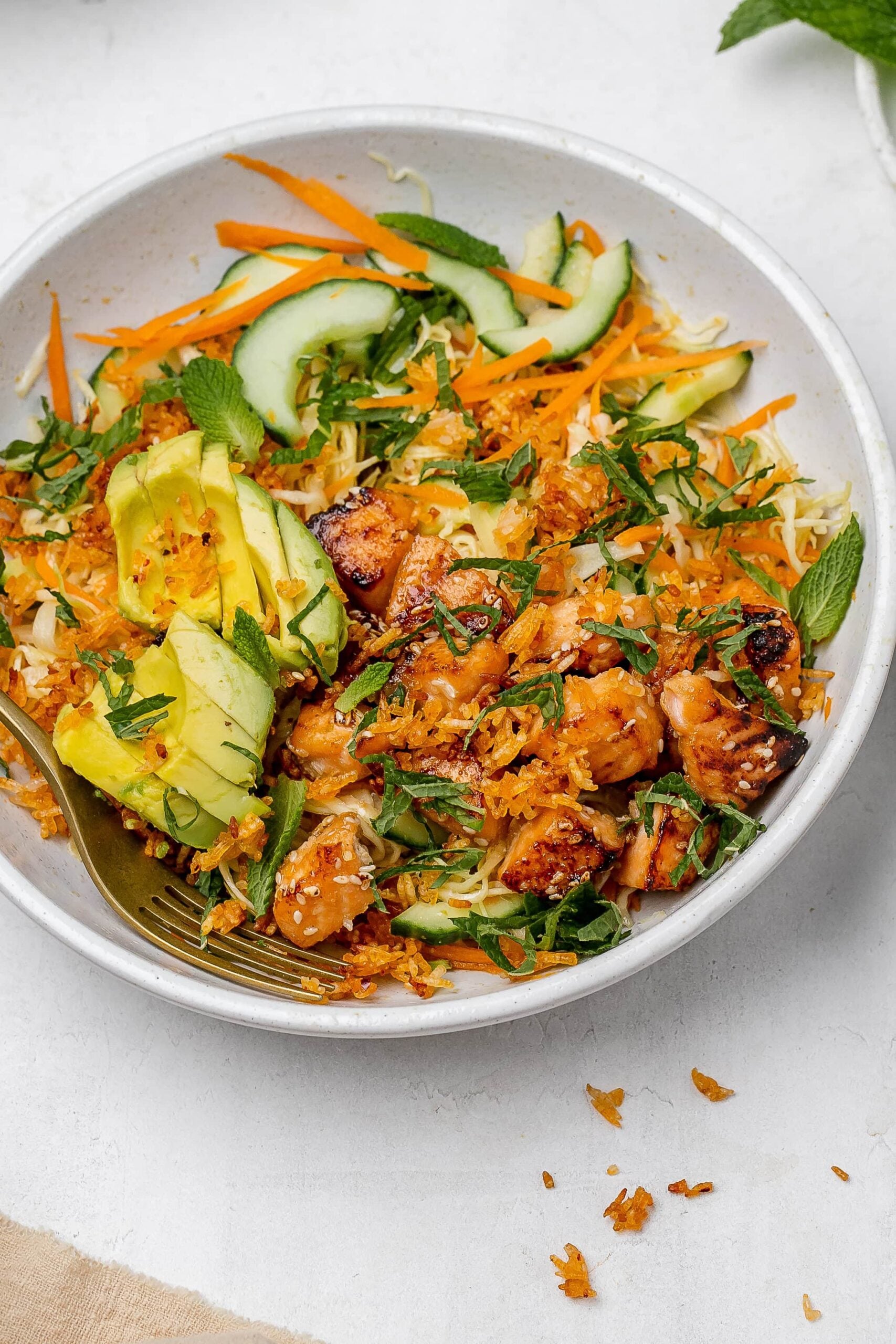 crispy rice salad with salmon in a salad bowl.